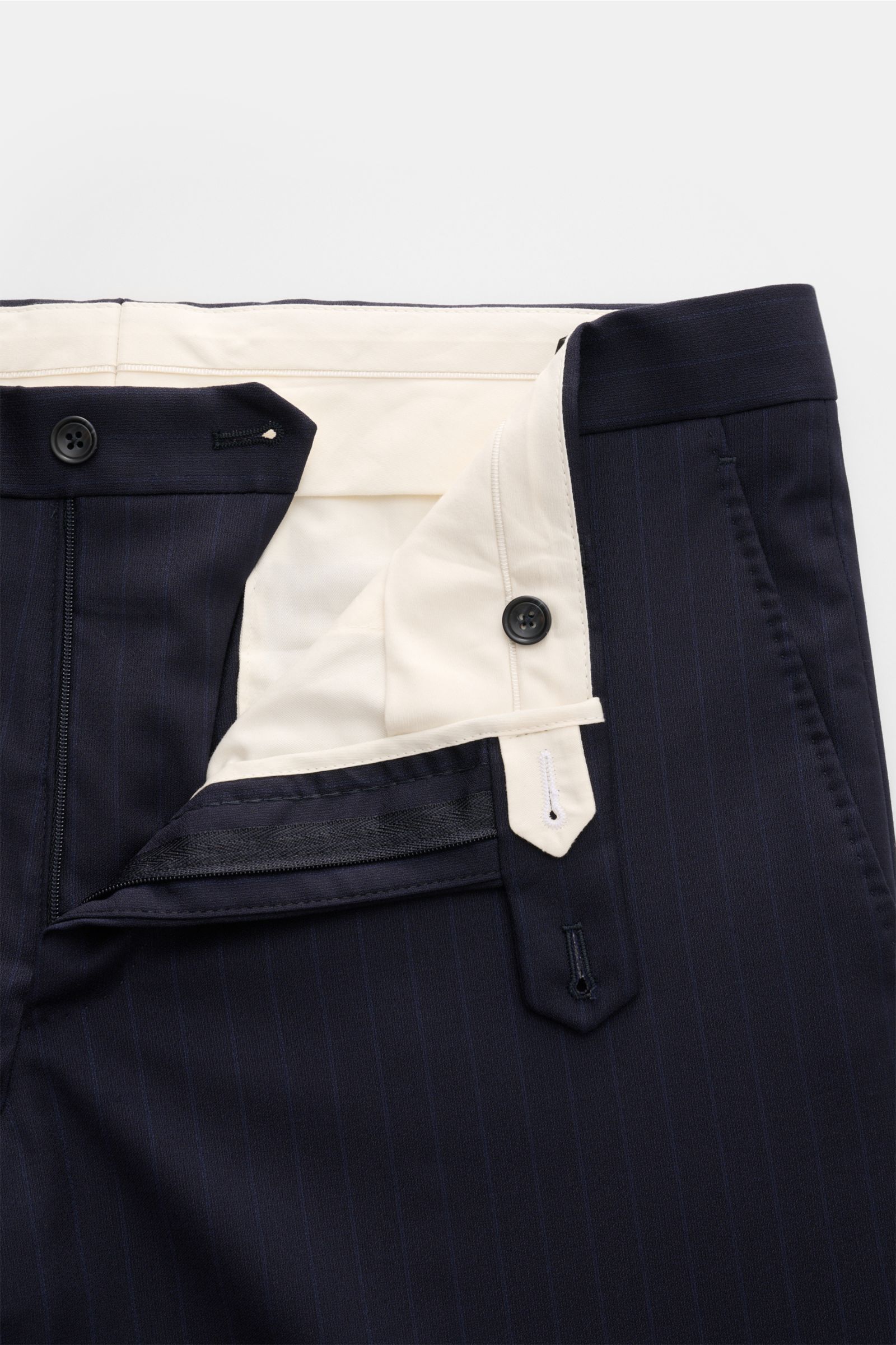 Close-up front view of navy pin-striped Tagliatore Anzug 'Vesuvio' pants, showing button, zipper, and beige inner lining, elastic wool.