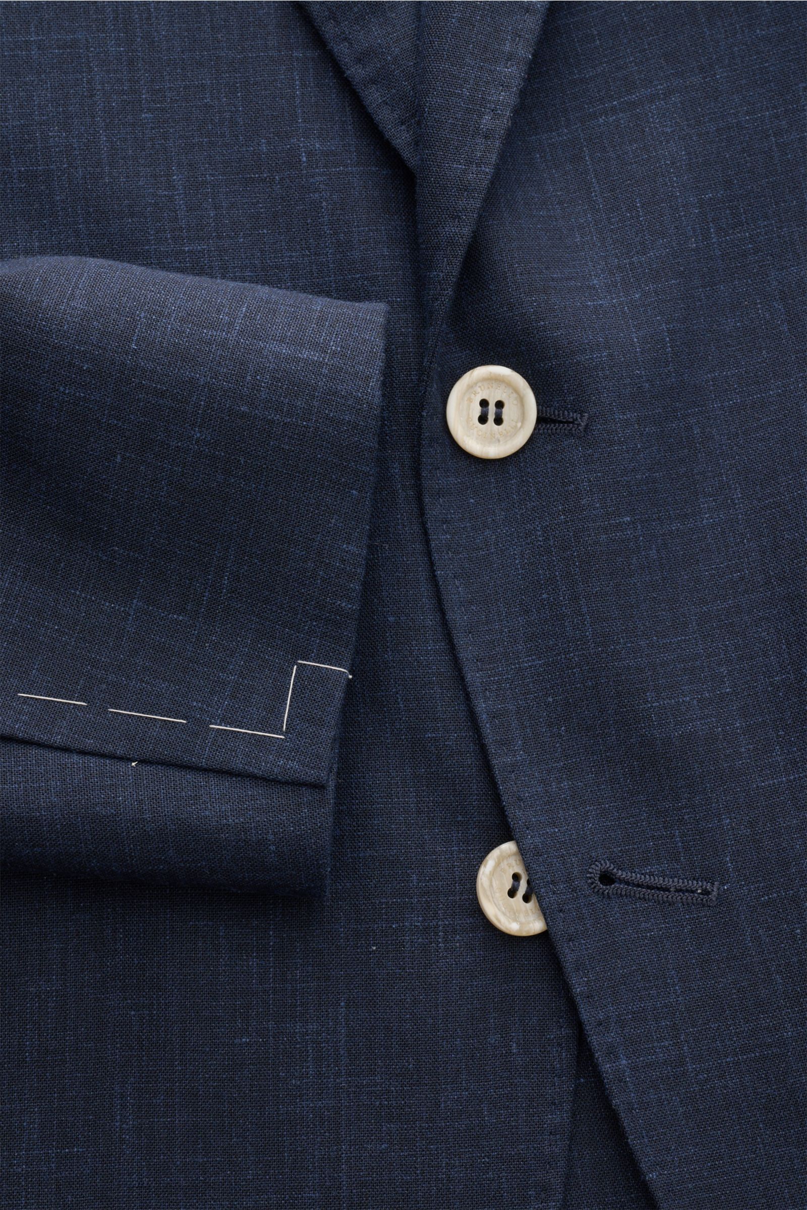 Close-up front view of the Brunello Cucinelli Anzug navy meliert, showing the textured navy melange fabric, beige buttons, and unfinished sleeve cuff. When Italian elegance meets luxurious craftsmanship, a suit like this Brunello Cucinelli Anzug navy meli