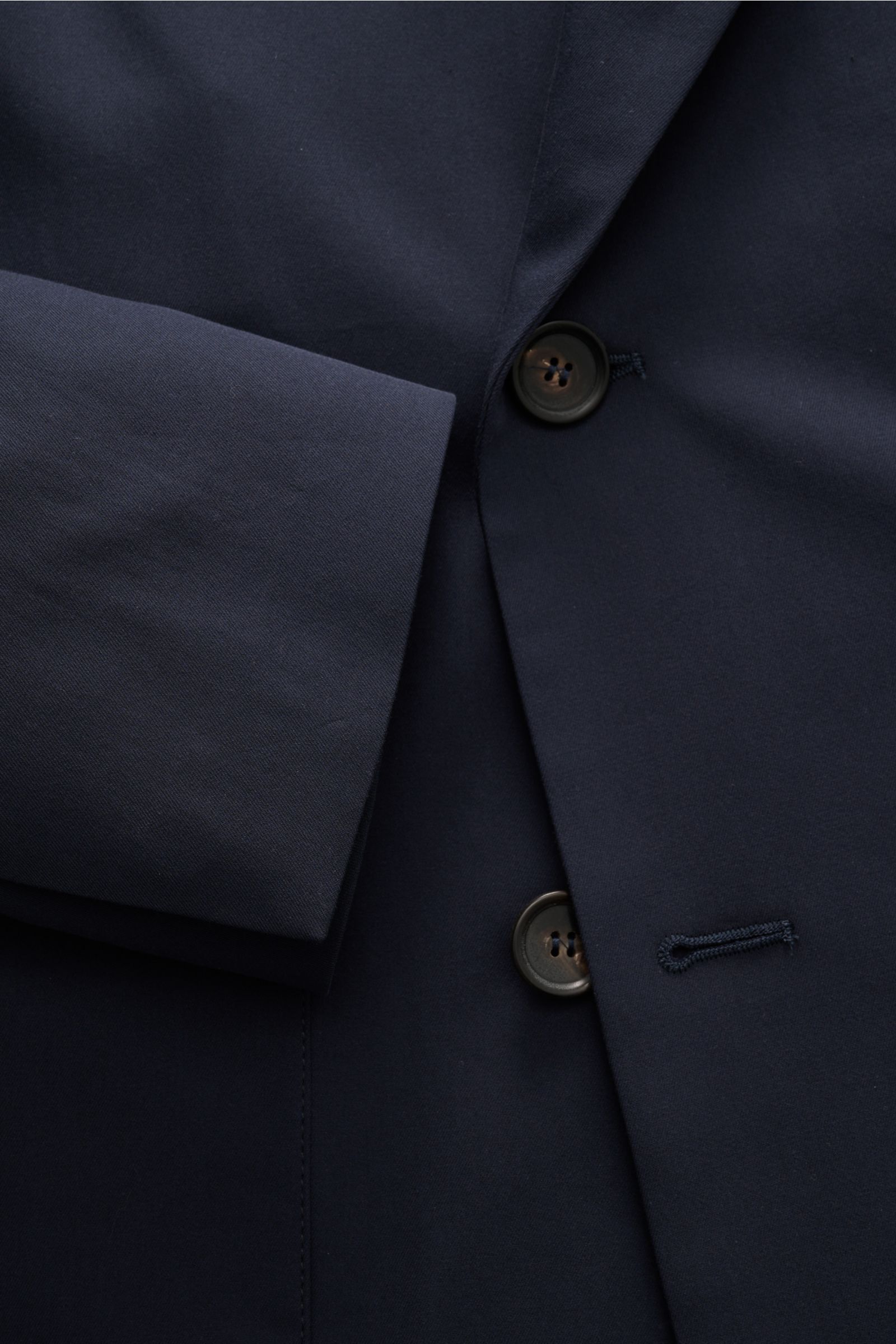 Nahaufnahme aus schräger Perspektive eines Knopfes und Ärmels des Doppiaa Anzugs 'Aanversant' navy aus reiner Baumwolle mit weichem Griff und Unconstructed Design.