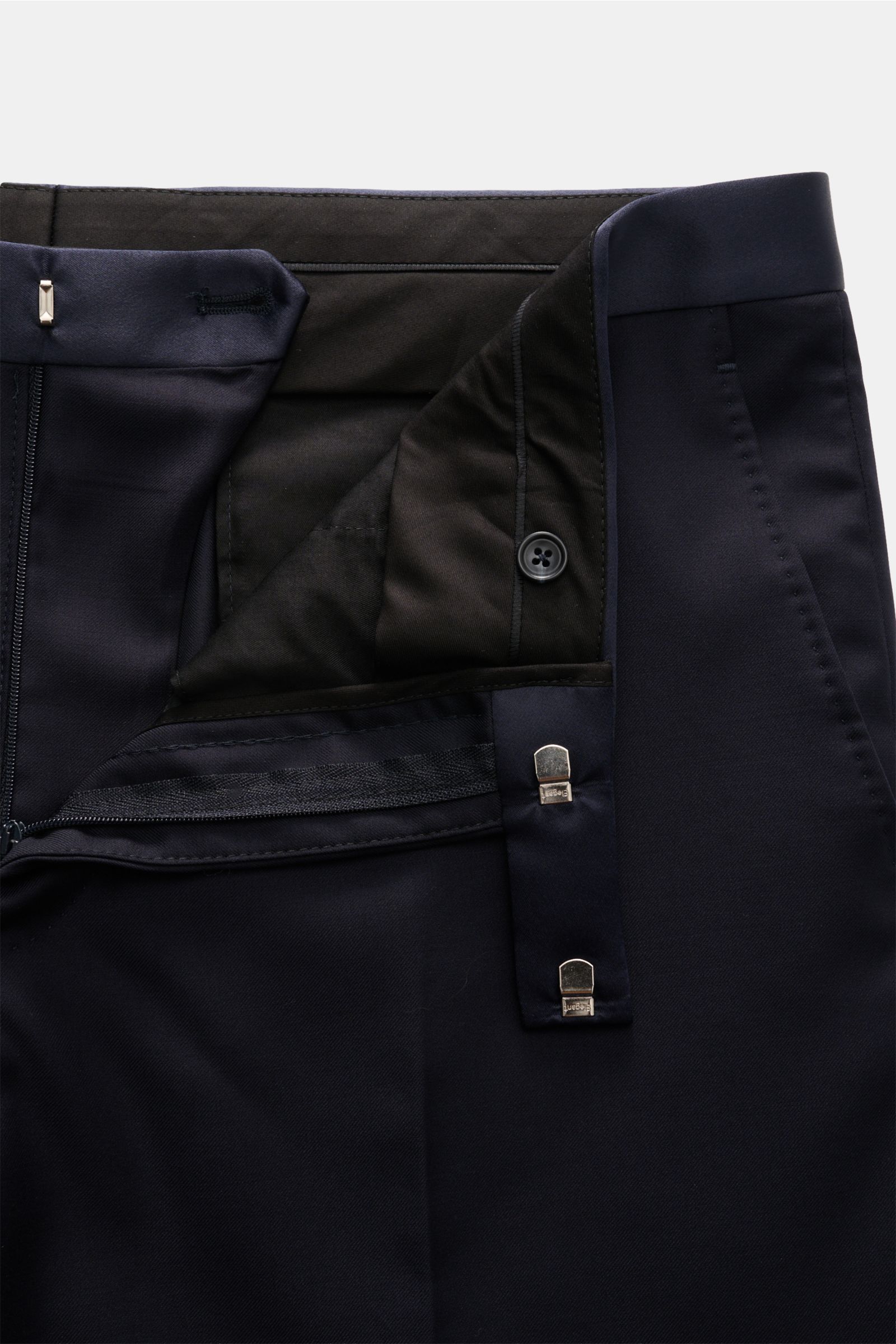 Close-up front view of the waist and fastening details of the Tagliatore Tuxedo navy trousers in pure Super 110'S virgin wool.