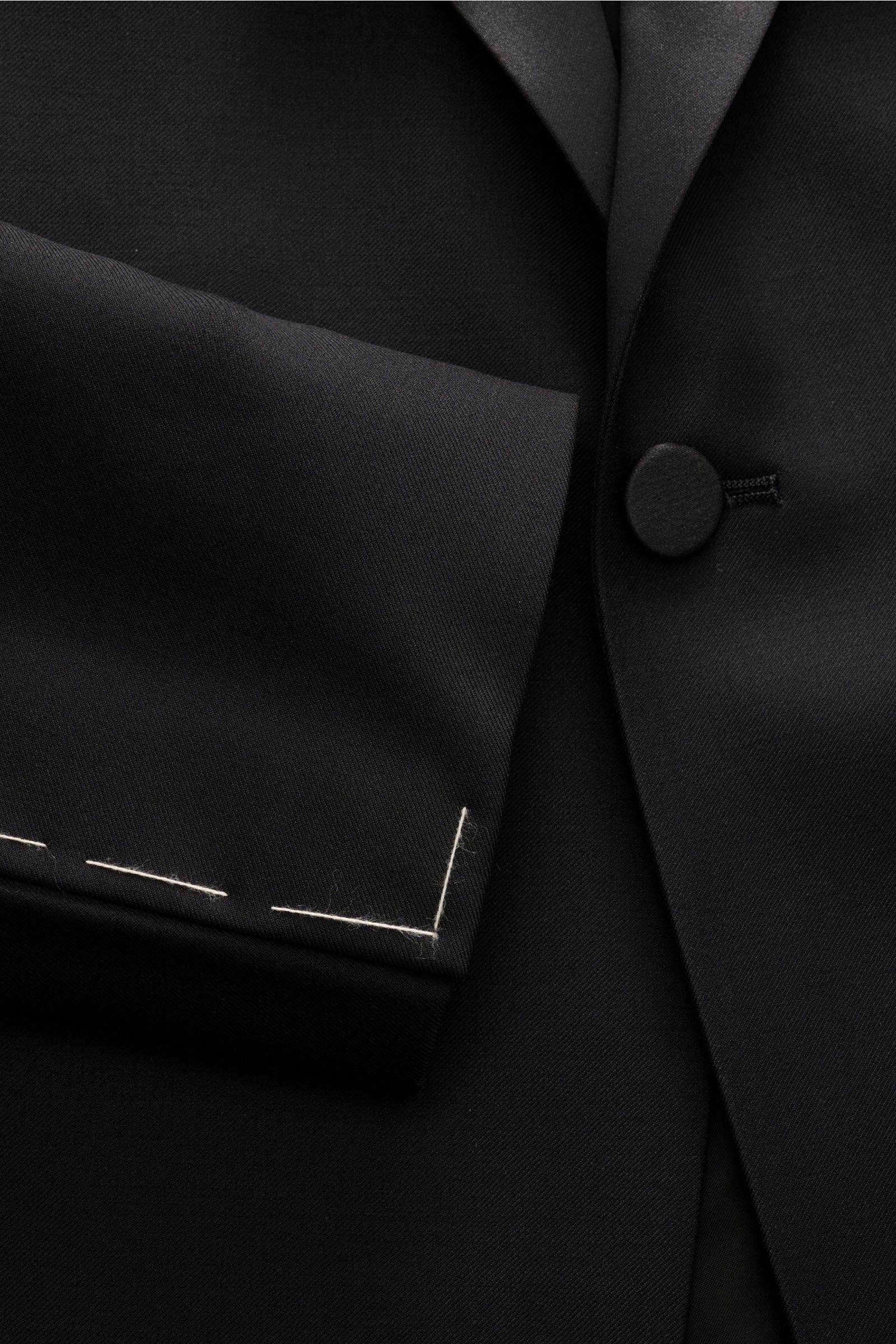 Close-up front view of Tagliatore Tuxedo black lapel and button in pure Super 110'S virgin wool with smooth feel, slim fit.