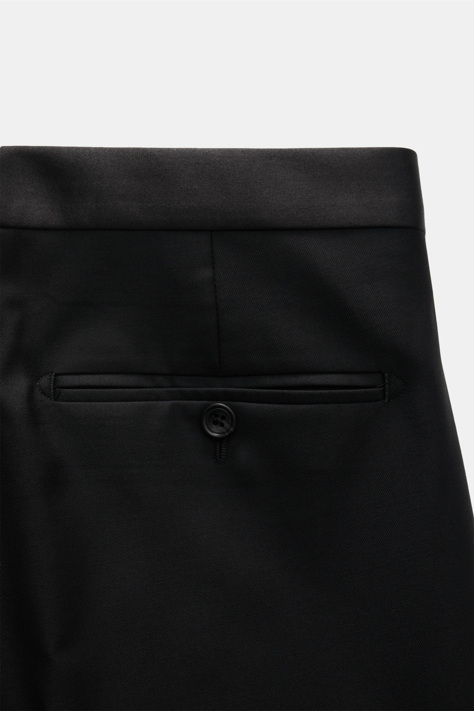 Close-up rear view of the waistband and back pocket of Tagliatore Tuxedo black trousers in pure Super 110'S virgin wool, slim fit with satin waistband and buttoned back pocket.