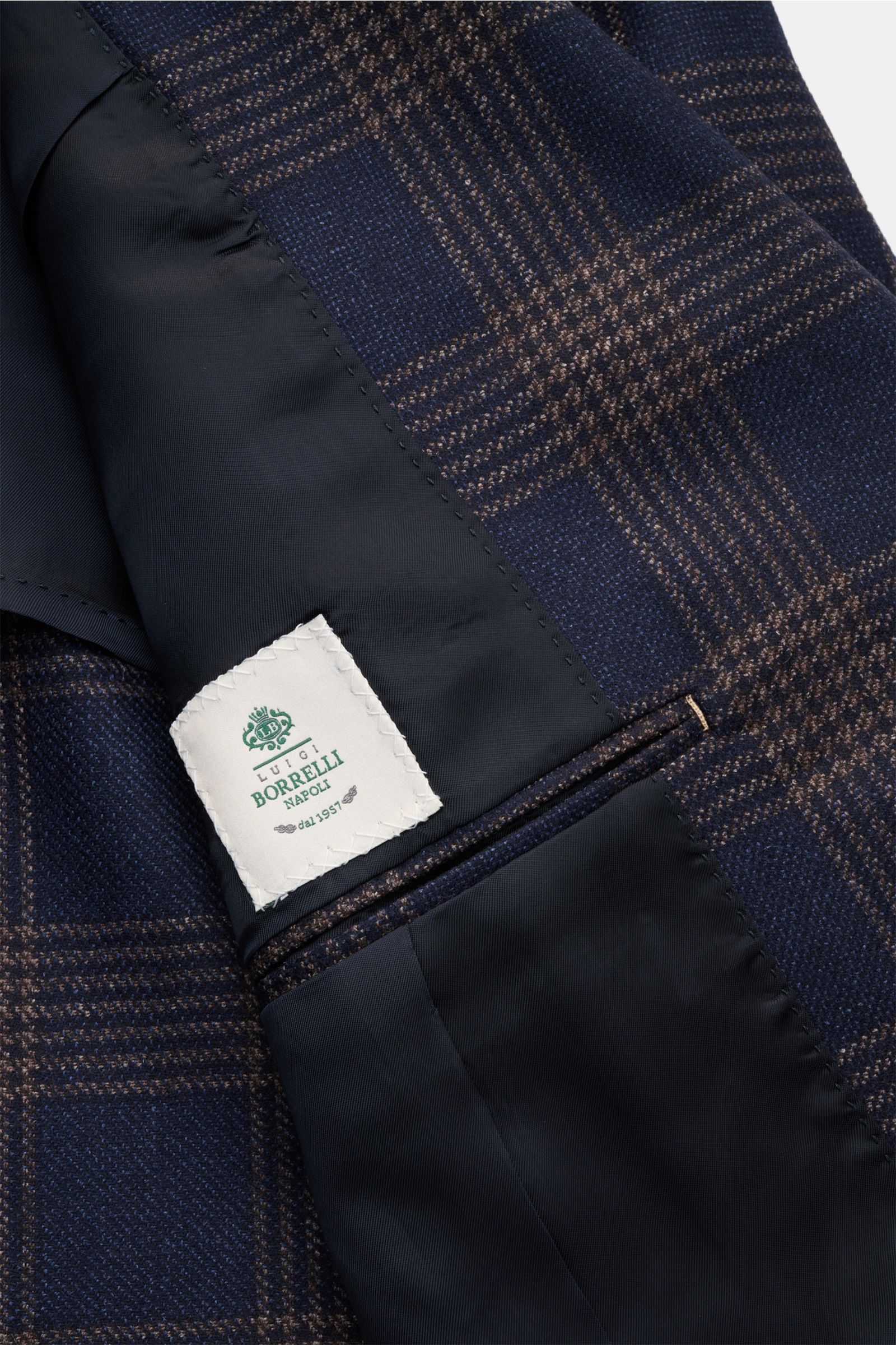 Close-up inside view of Borrelli Smart-casual jacket 'Procida' dark blue/beige checked, showing blend of wool, silk and linen, stable feel, classic checked pattern, slim fit, fitted three-button style, step lapel, classic breast pocket, patch hip pockets,