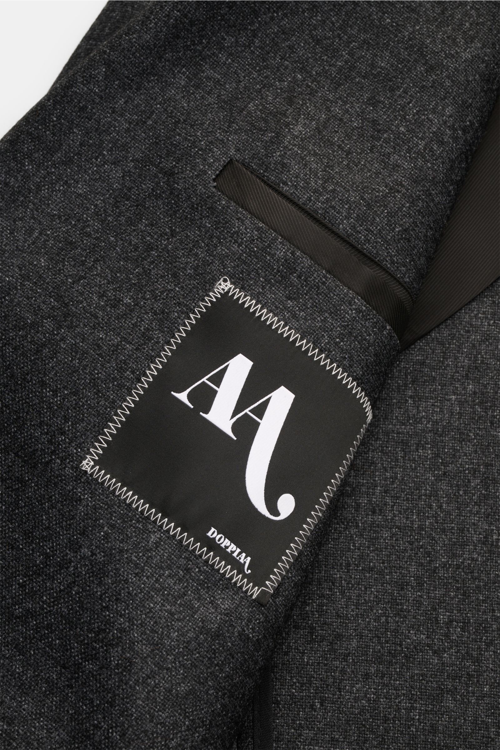 Close-up of the Doppiaa Sakko 'Aantilope' anthrazit meliert showing the inner pocket and label, photographed from the inside front.

Sportiv elegant: Das Sakko 'Aantilope' von DOPPIAA vereint edlen Cashmere-Mix mit geradem Schnitt im Zwei-Knopf-Stil – 