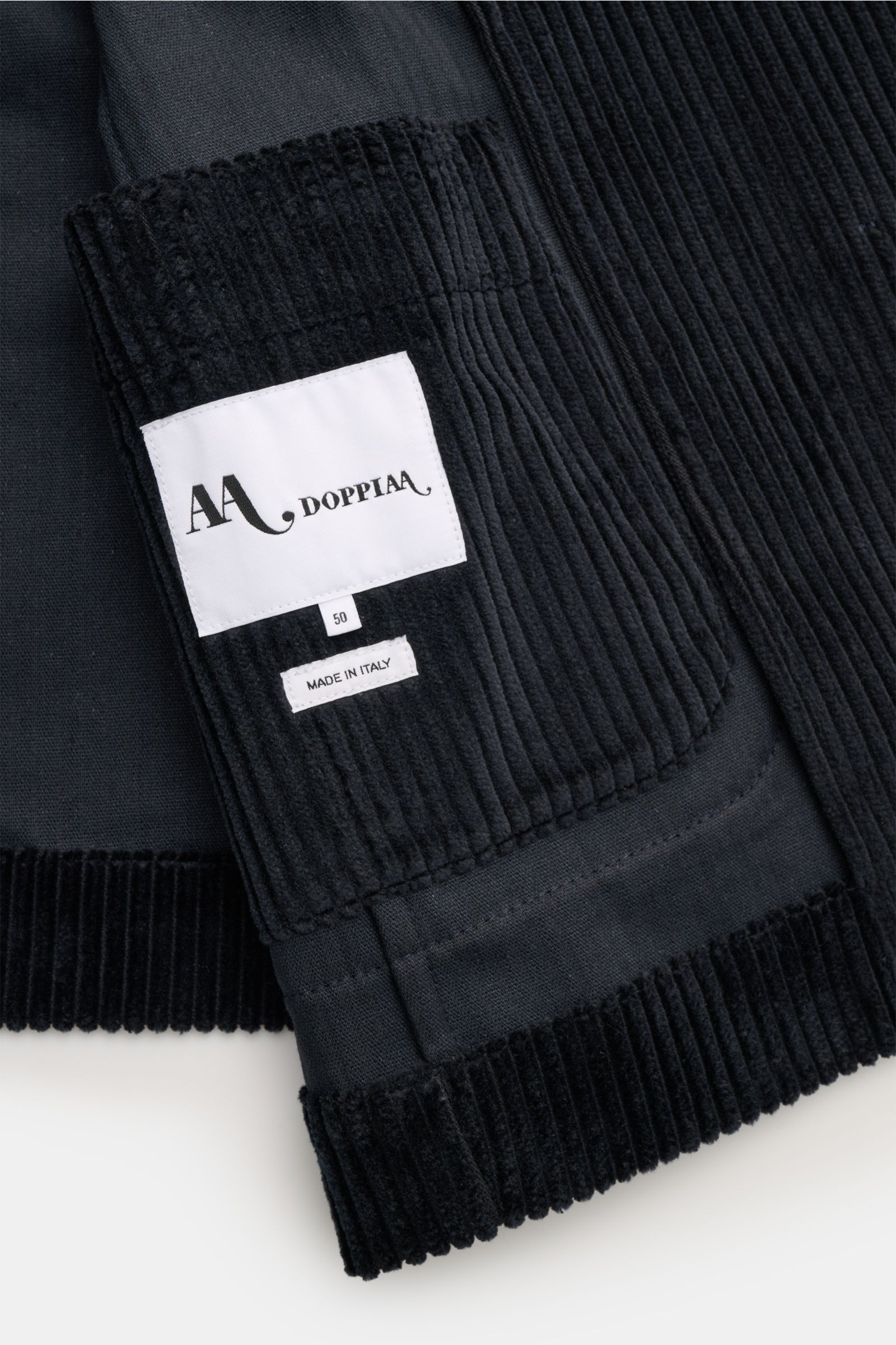 Close-up image from above of the Doppiaa Corduroy smart-casual jacket 'Aansonia' navy showing cotton corduroy fabric, slim fit, double breasted three-button style, pointed lapel, patch hip pockets, sleeve cuff with concealed button, side vents at the back