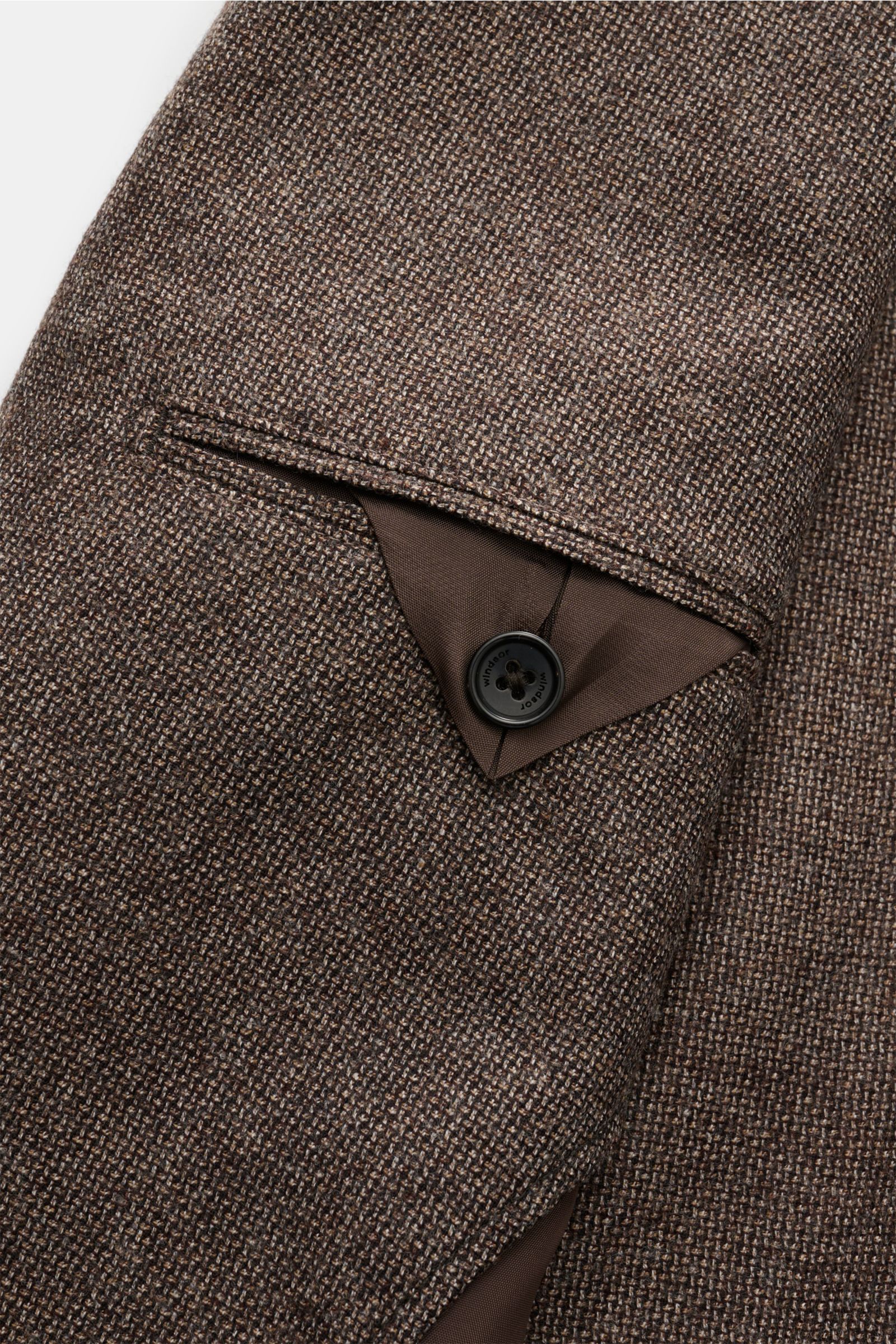 Close-up angled view of the sleeve and cuff of the Windsor Smart-casual jacket 'Giro' grey-brown mottled, showing plain weave in virgin wool, soft feel, slim fit, step lapel, two-button style, classic breast pocket, patch hip pockets, kissing buttons, sid