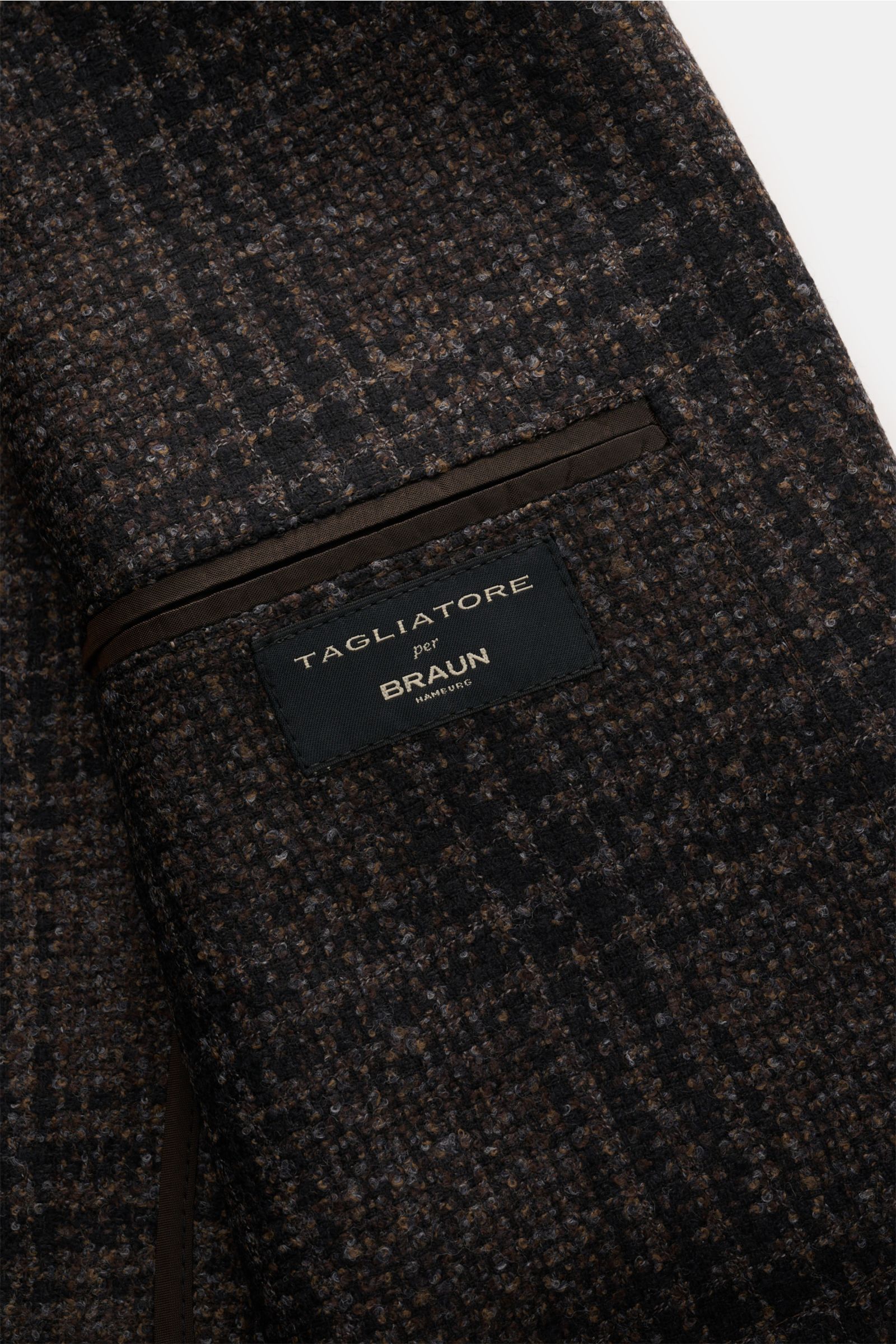 Tagliatore Sakko 'Monte Carlo' schwarz/braun/grau kariert, Detailansicht der Brusttasche und Label, Woll-Mix mit Glencheck und Unconstructed-Verarbeitung.
