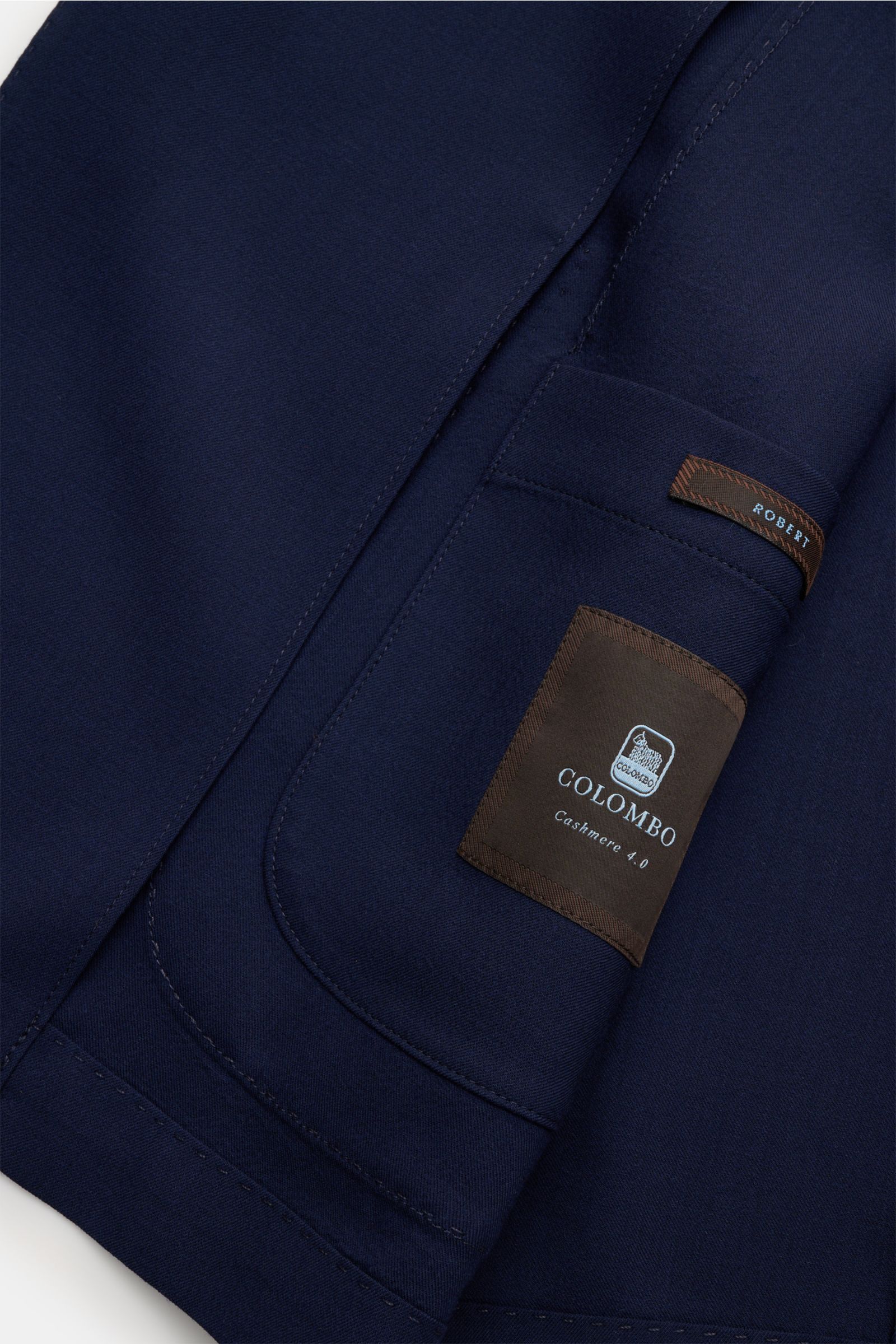 Close-up inside view of Colombo Cashmere blazer navy showing the patch pocket and label with stitching details.

Pure luxury from specialists COLOMBO: This lightweight blazer in super soft cashmere is the perfect layering piece for modern office looks.