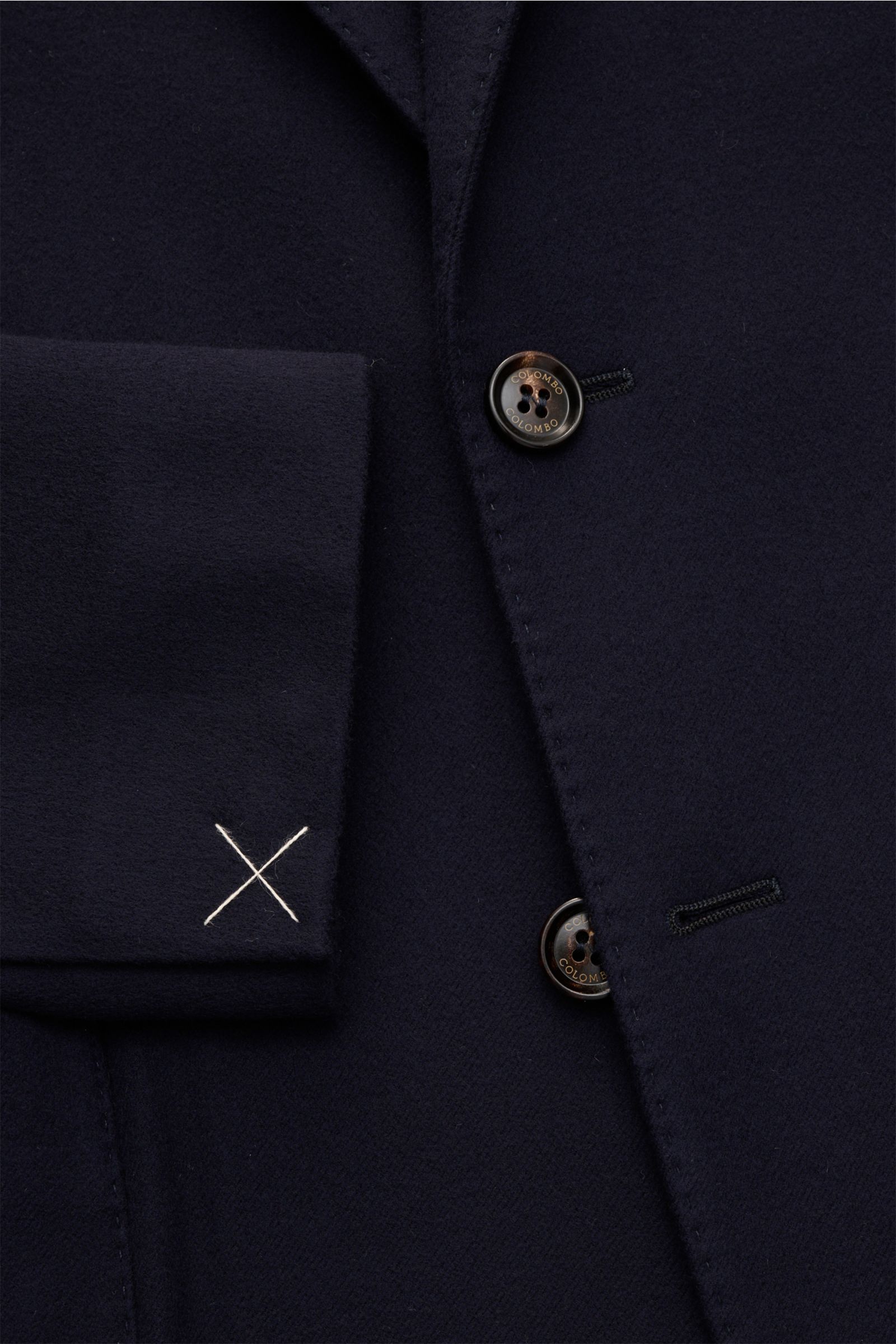 Nahaufnahme des Colombo Sakko navy aus reiner Wolle mit tailliertem Zwei-Knopf-Stil, fallendem Revers, weichem Griff und sichtbaren Details wie Ärmel mit weißem Kreuzstich.
