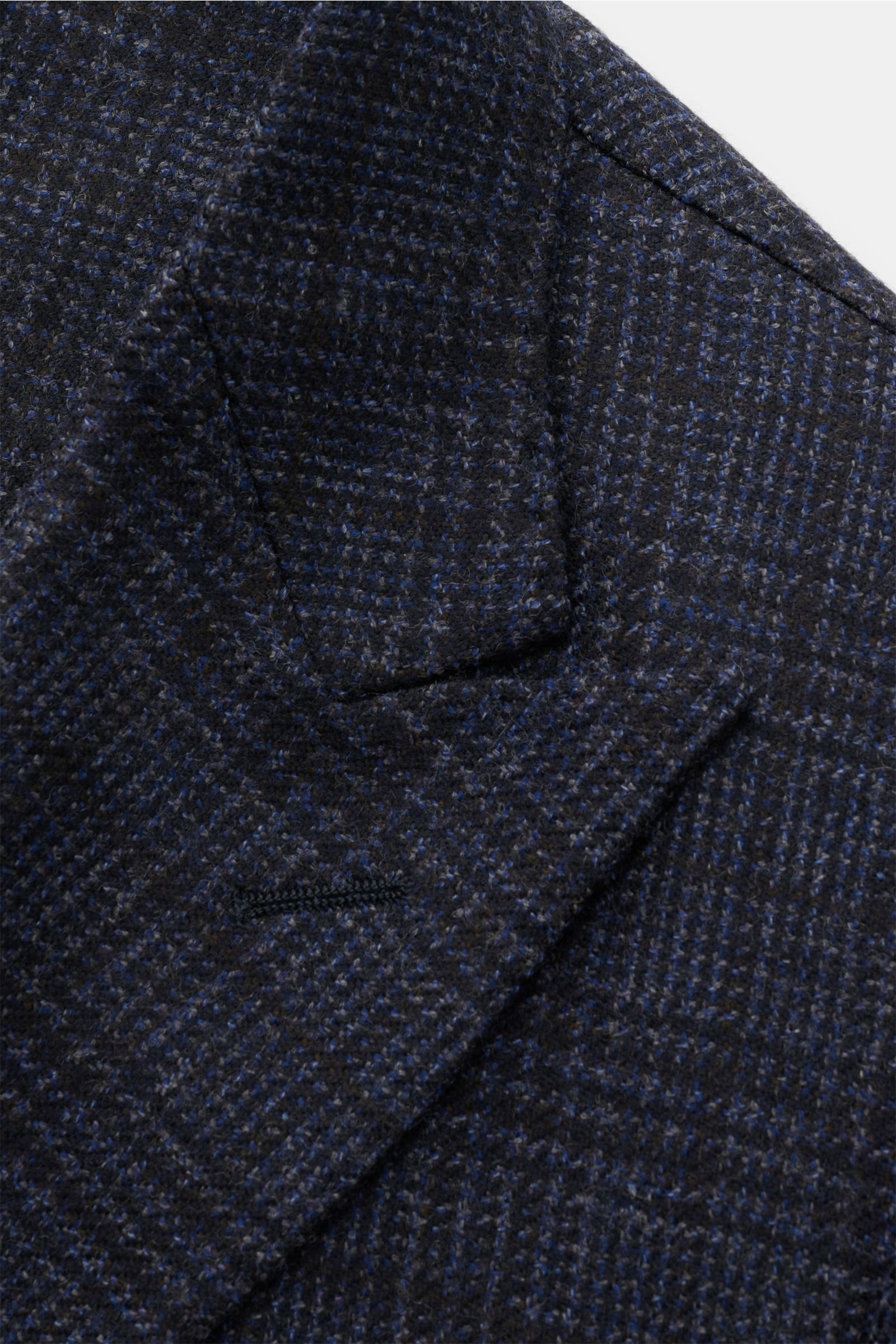Close-up front view of the Santaniello Smart-casual jacket dark blue/grey/black checked showing its fine wool fabric, classic glen check, pointed lapel, and subtle texture, embodying classic elegance for the new season.

Classic elegance for the new se