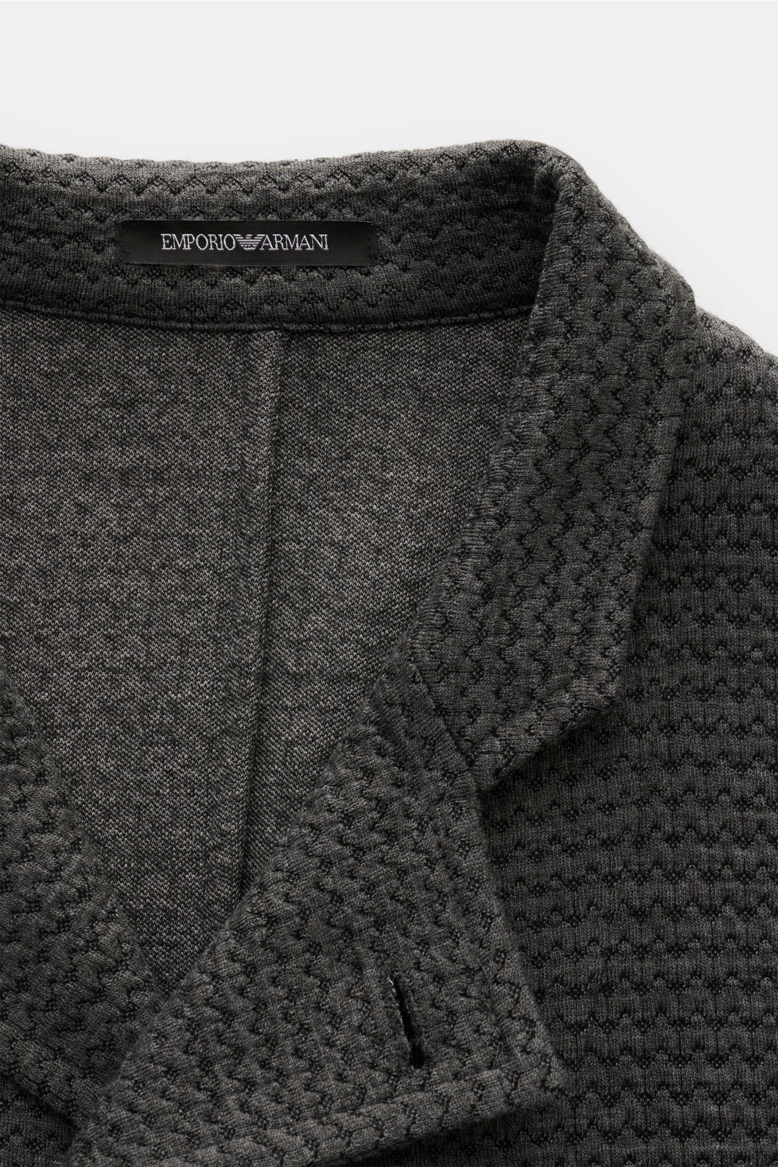 Close-up front view of Emporio Armani Strickblazer dunkelgrau meliert showing soft wool blend textured knit fabric with slim fit, five-button style, and unconstructed design.