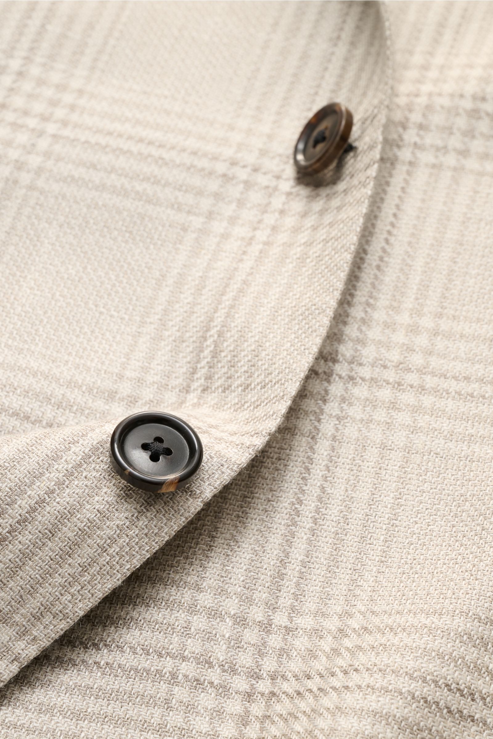 Close-up front detail of Corneliani Smart-casual jacket light grey/cream checked showing two buttons and classic glen check fabric texture.

Description:
Stylish and uncomplicated – with its comfortably lightweight blend of wool, silk and linen and its