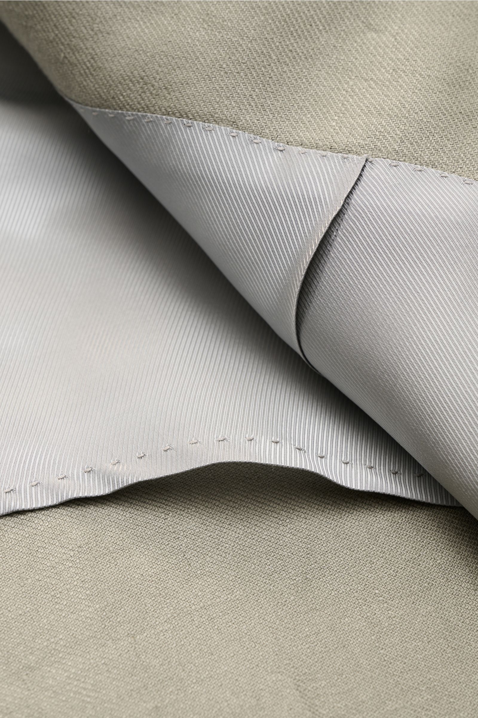 Nahaufnahme des Innenfutters und der feinen Webstruktur des Corneliani Leinensakko salbei aus reinem, softem Leinen.