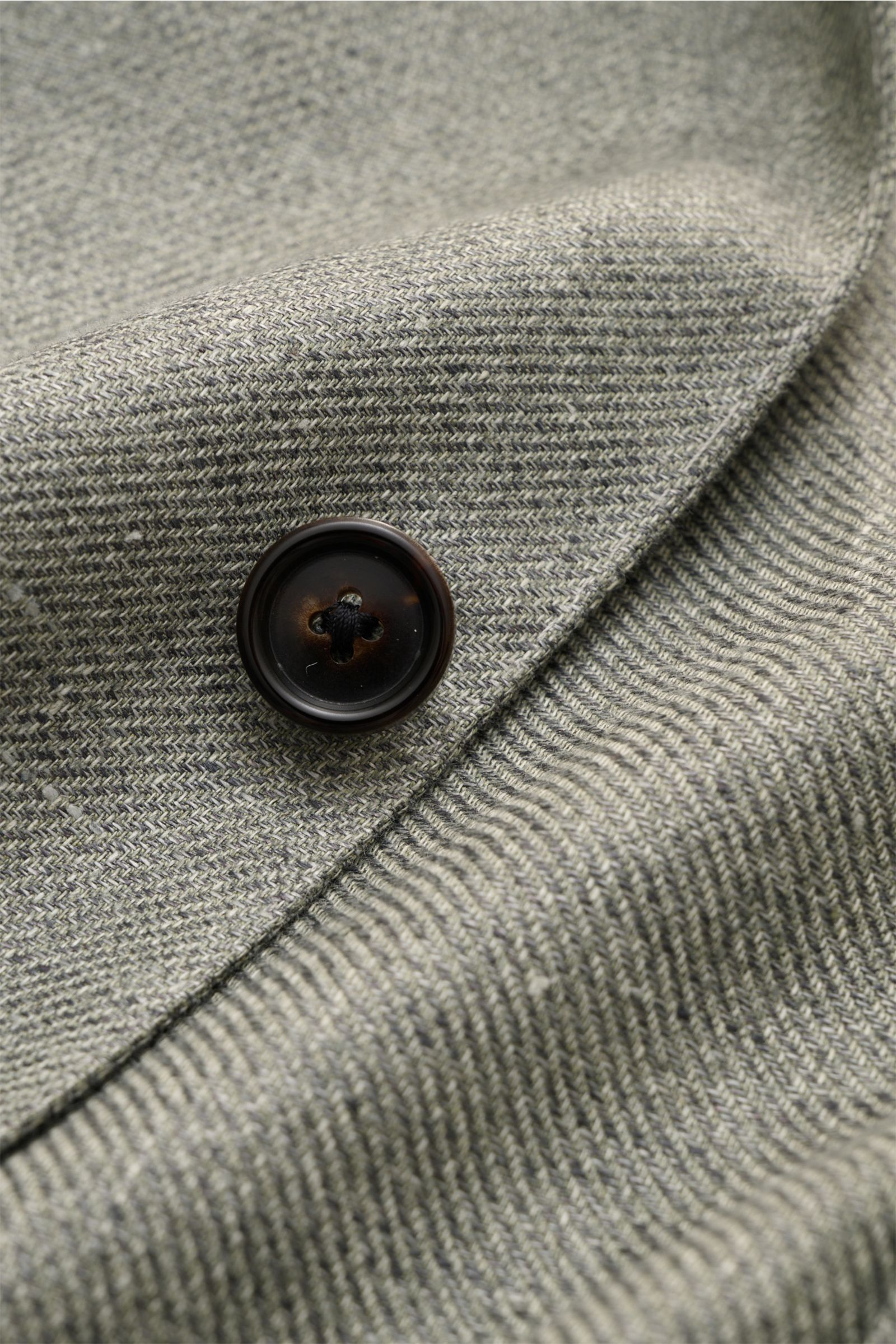 Close-up front view of Corneliani Smart-casual jacket sage mottled, focusing on black button and textured lyocell-linen fabric.

Description: Superlative style from CORNELIANI: in a optimal fit made with Italian expertise, this smart-casual jacket in l