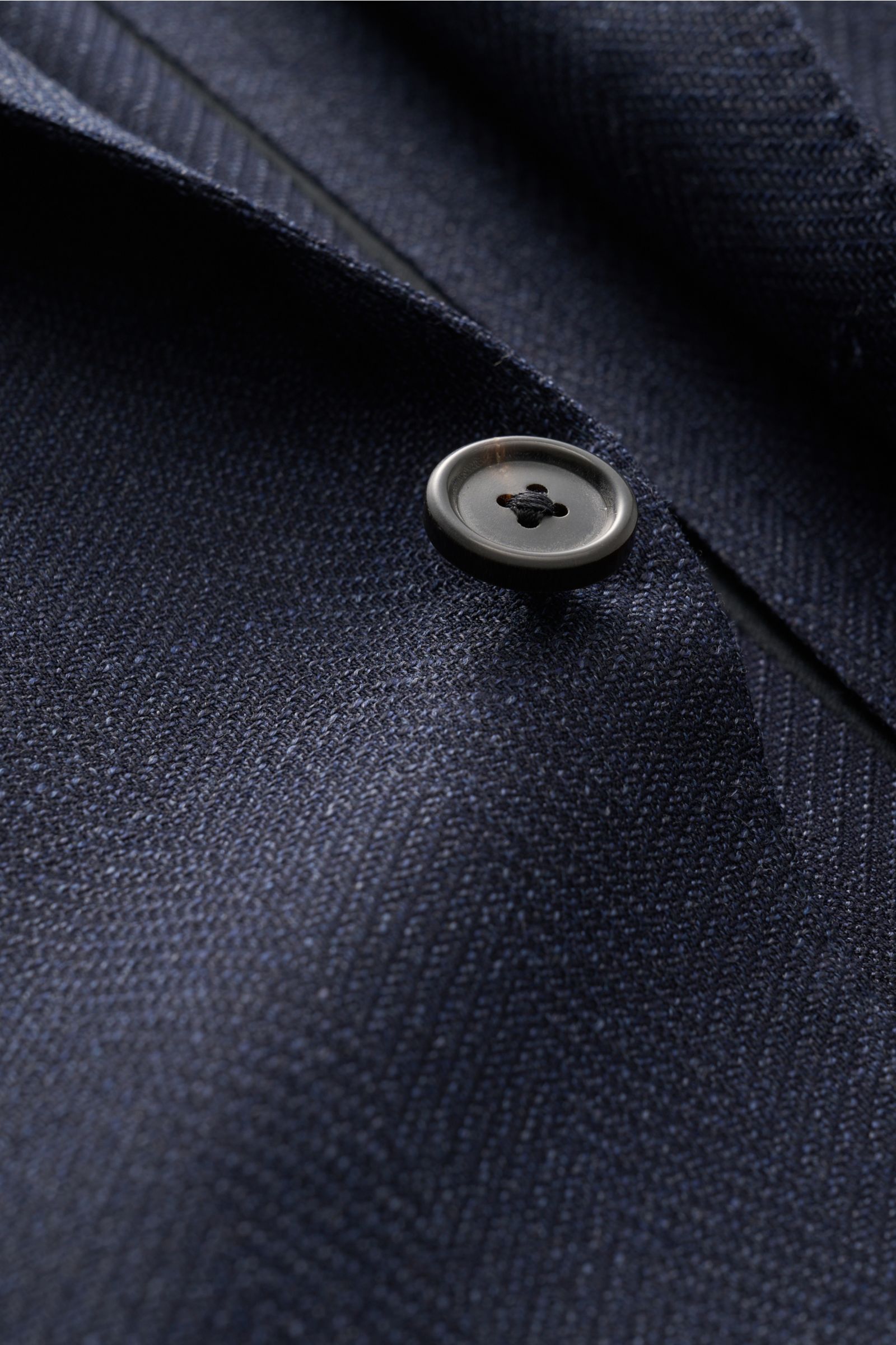 Close-up front view of Corneliani Smart-casual jacket navy mottled showing navy elastic virgin wool fabric, distinctive weave, and button.