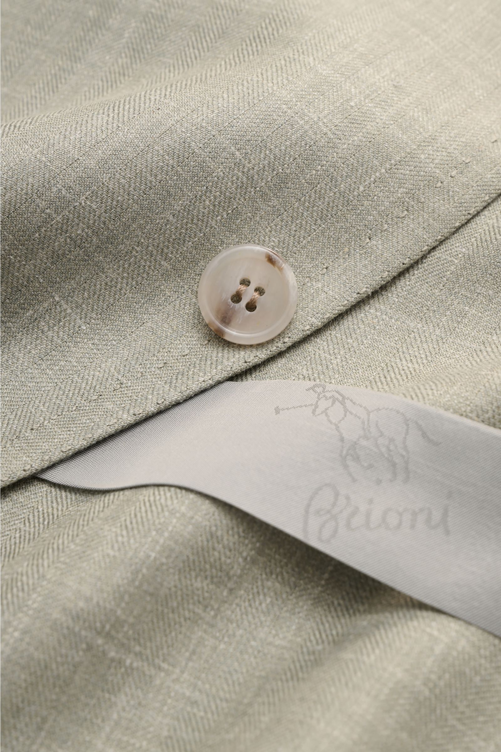 Close-up front view of Brioni Smart-casual jacket 'Amalfi' sage mottled showing wool-silk-linen fabric, button, and inner label.