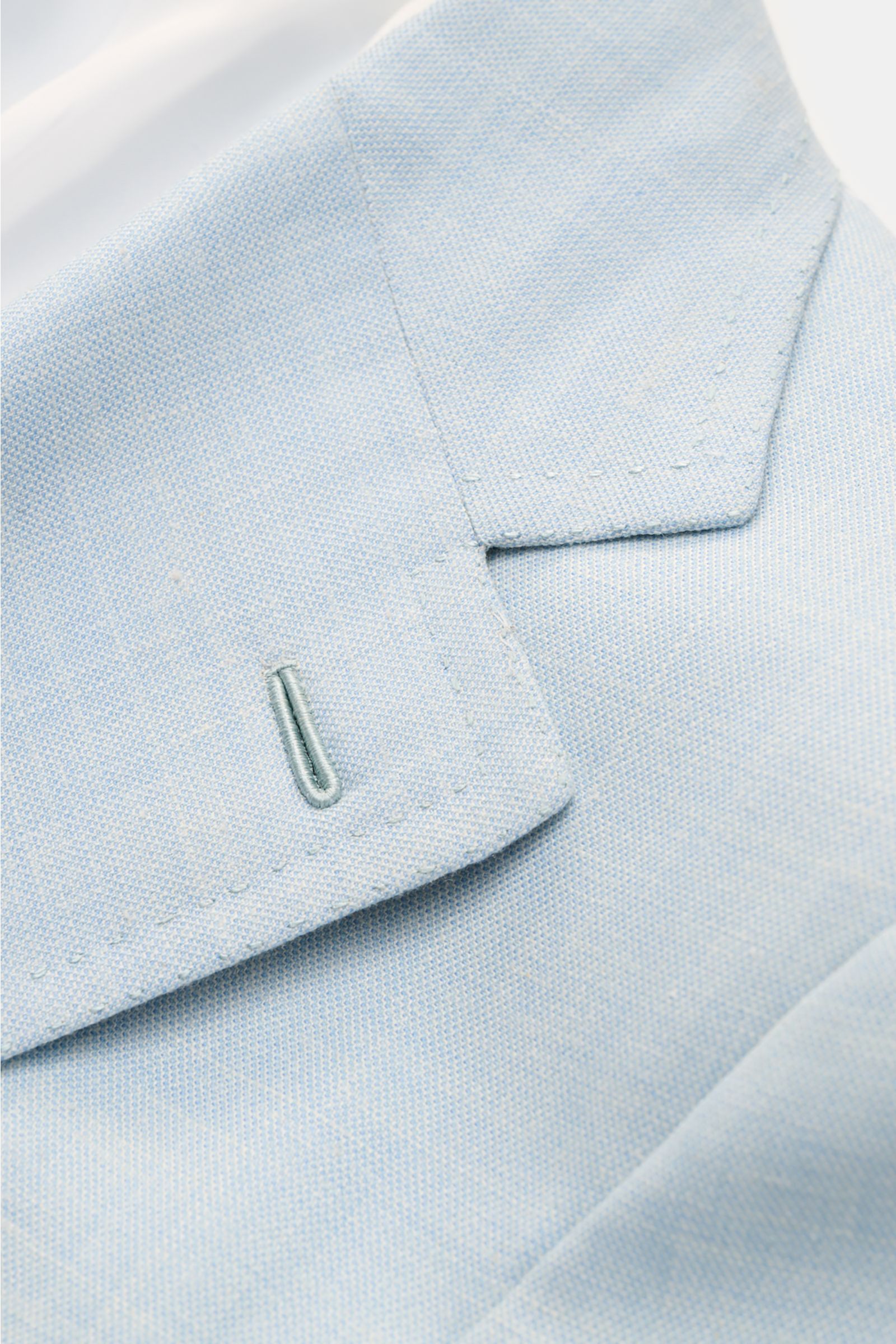 Close-up front angle of the Brioni Smart-casual jacket 'Amalfi' pastel blue mottled, showcasing its wool-silk-linen blend, soft feel, slim fit, fitted three-button style, step lapel, classic breast pocket, patch hip pockets, unfinished sleeve cuffs, side 