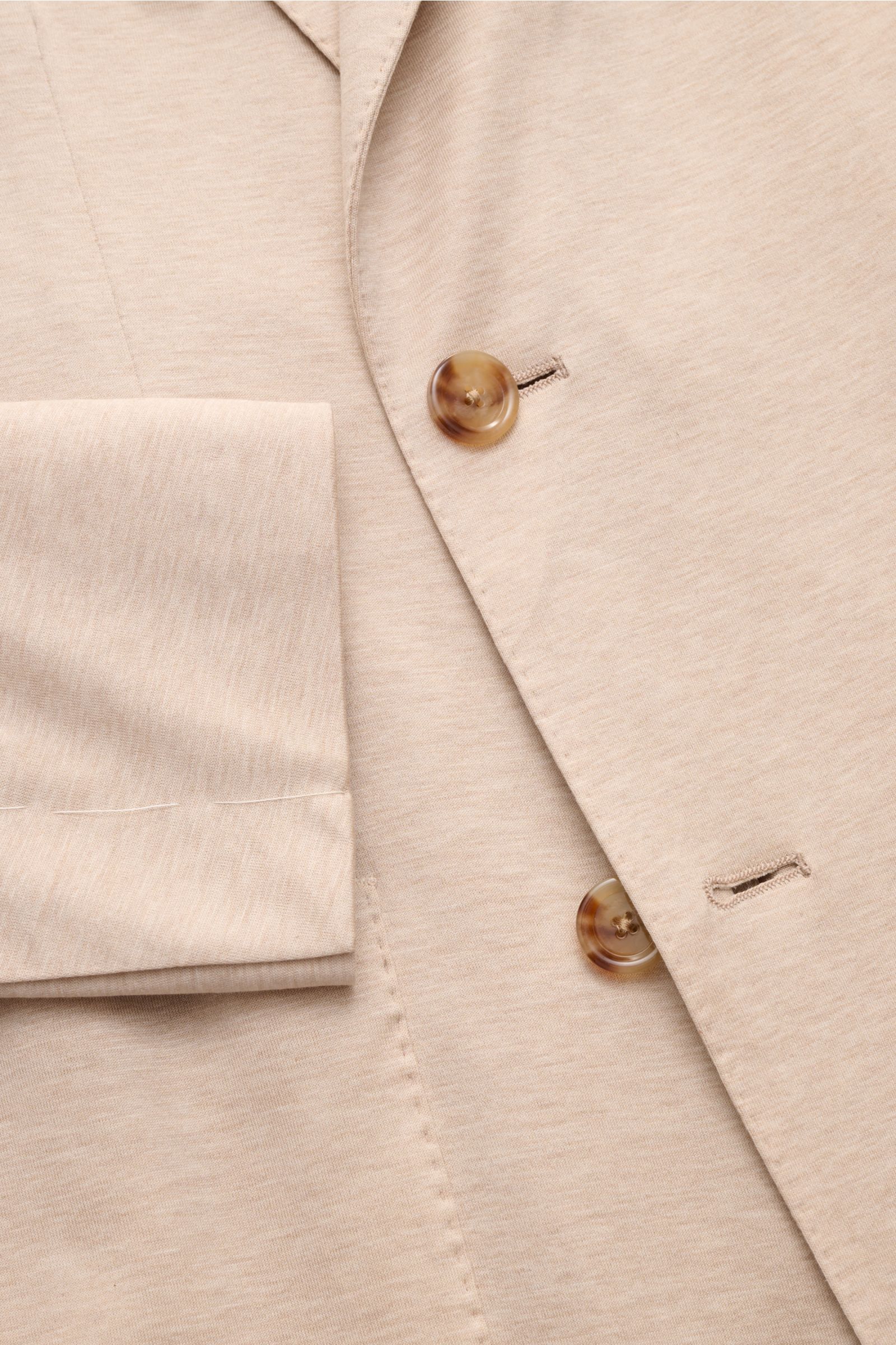 Close-up front view of Lardini Jersey jacket beige mottled showing double-breasted buttons, soft cotton jersey fabric, and unfinished sleeve cuff.

Comfortable and elegant: This double-breasted smart-casual jacket by LARDINI in lightweight cotton jerse