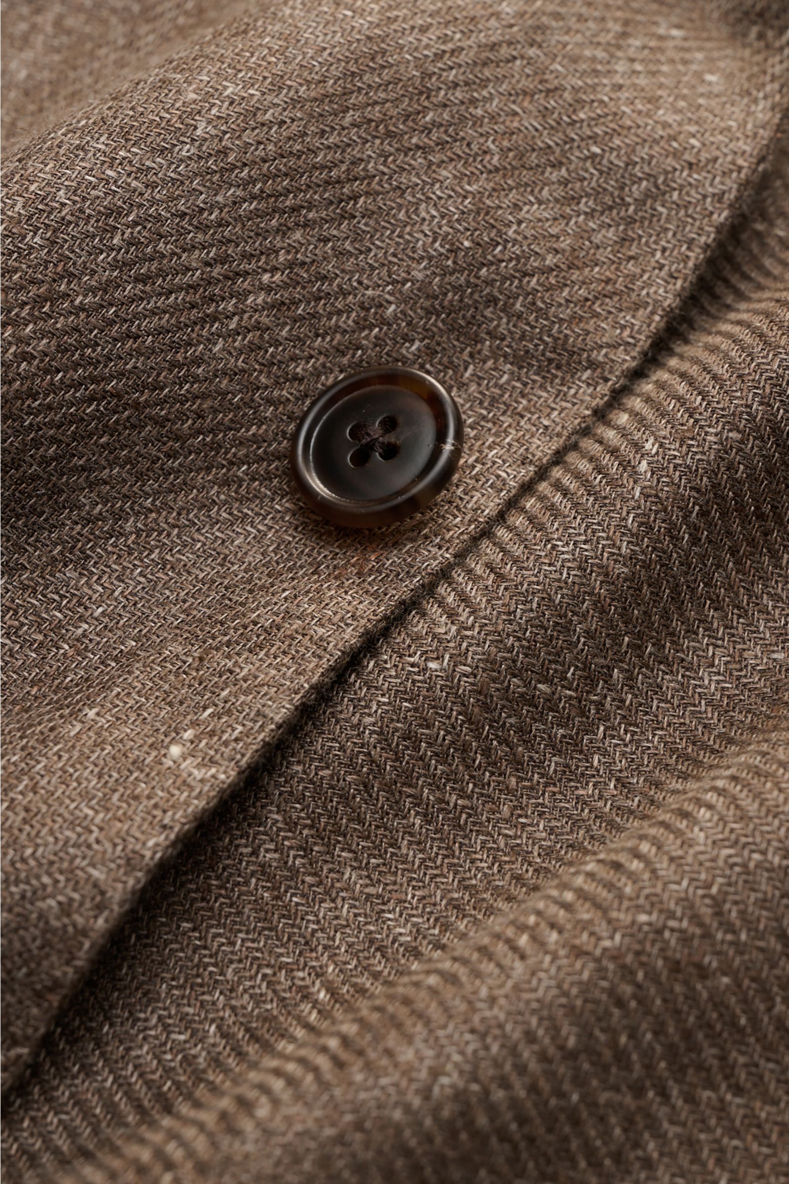 Close-up front angled view of Belvest Smart-casual jacket grey-brown melange showing linen and wool blend fabric texture and button detail.

Linen and wool form the basis for this unconstructed smart-casual jacket from label BELVEST which can be worn a