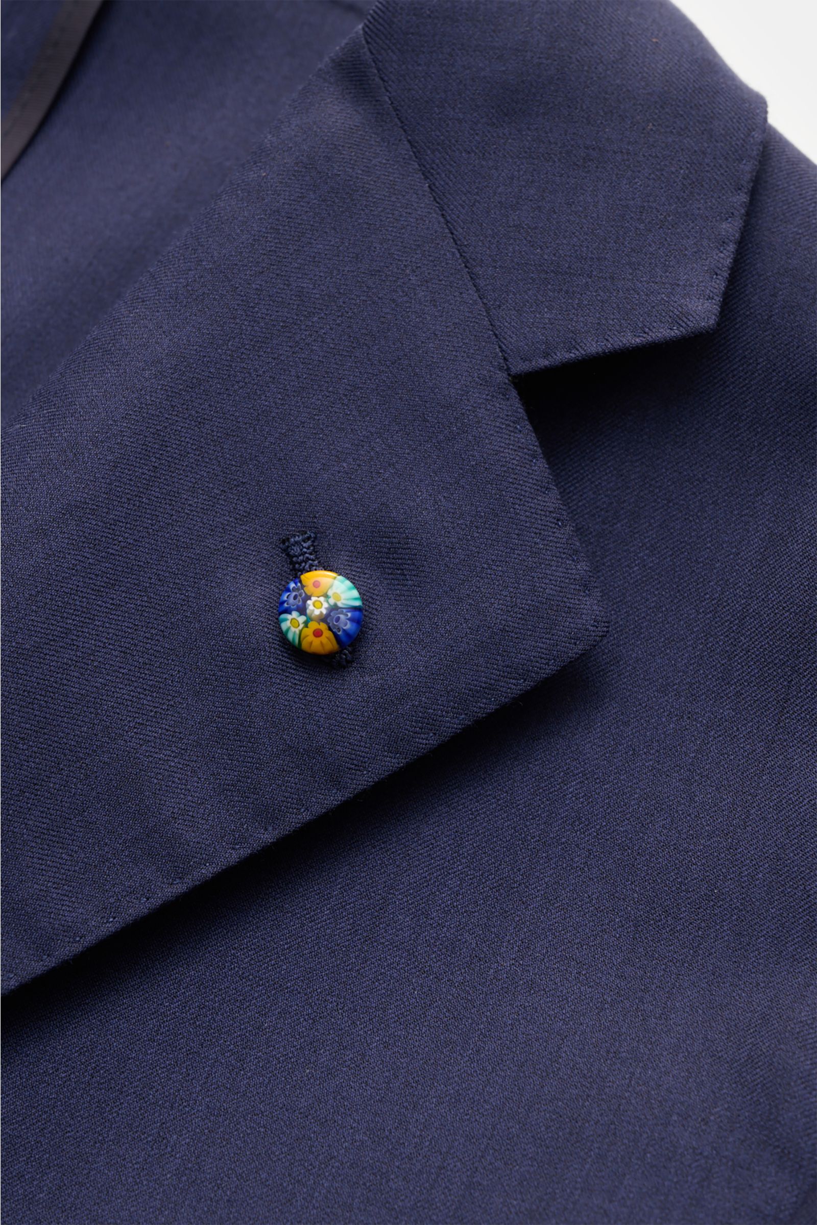 Close-up front angle of Belvest Smart-casual jacket navy lapel with colorful pin, showcasing fine wool-silk twill fabric texture.

BELVEST combines super soft fabric in a fine wool-silk blend in this smart-casual jacket with fine twill in fitted three-