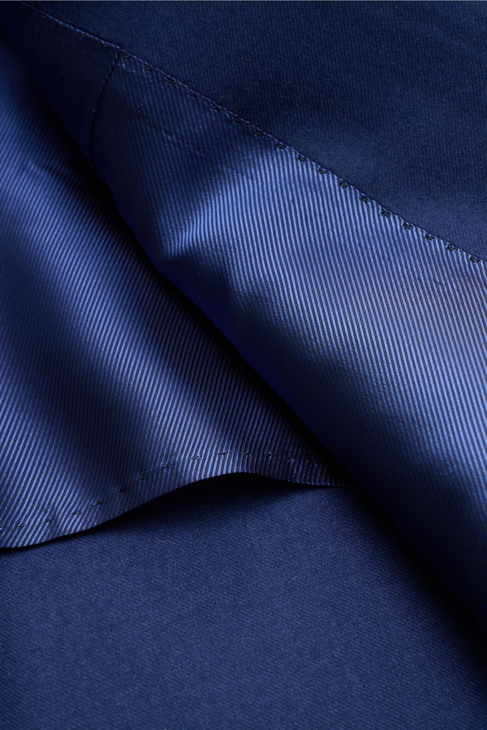 Close-up view of the dark blue lining and fabric detail of the Cesare Attolini Cashmere smart-casual jacket dark blue, showing fine stitching and texture. Enjoy luxury from CESARE ATTOLINI: This timeless smart-casual jacket in the finest pure cashmere has