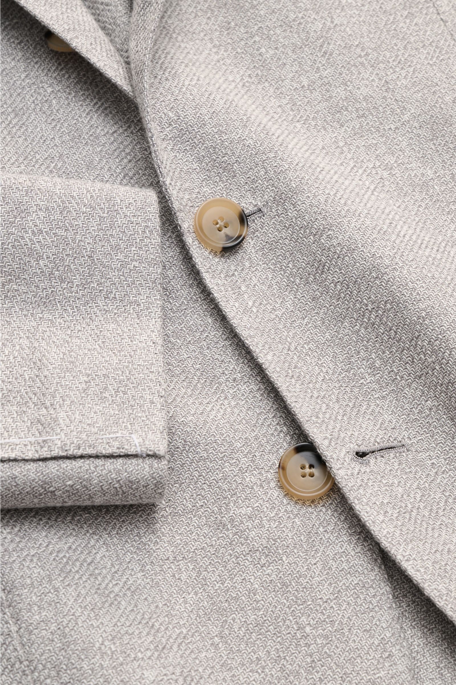 Close-up front perspective of Borrelli Smart-casual jacket 'Procida' grey/off-white mottled, showing slim fit, step lapel, and three-button style.

Business elegance in a summery design: With its lightweight material and exceptional feel, the smart-cas