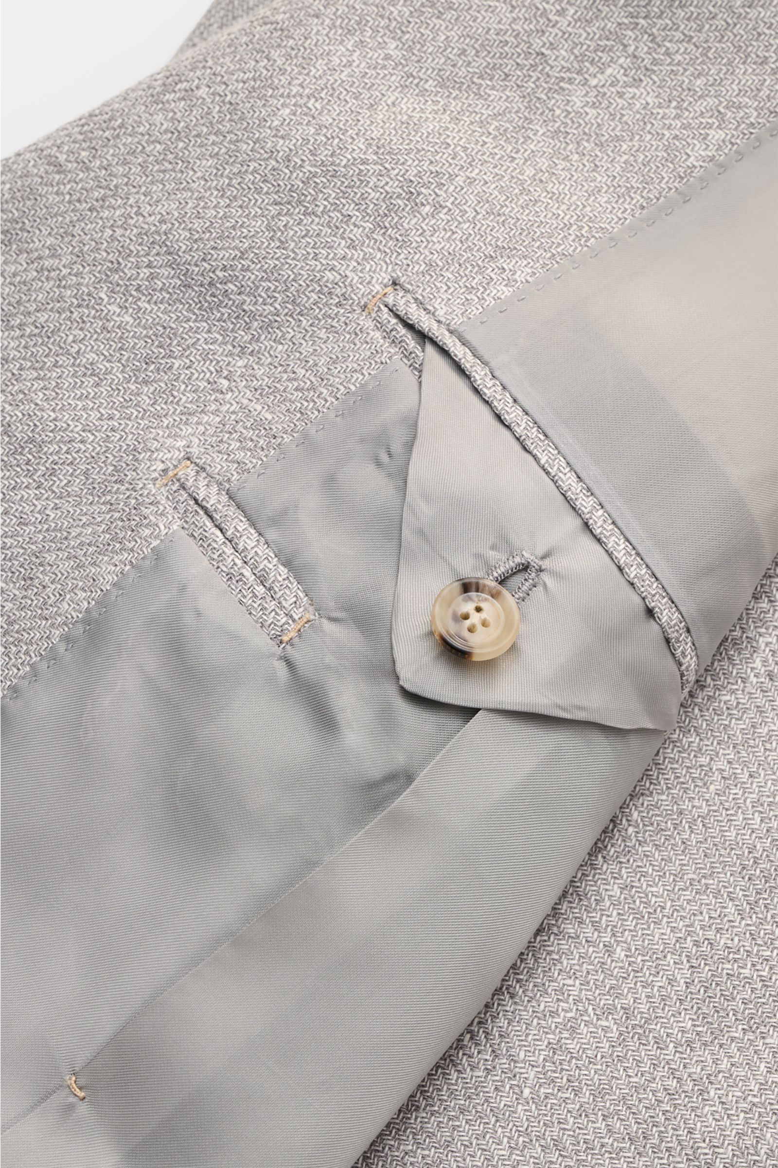 Close-up view of the inside cuff and fabric texture of the Borrelli Smart-casual jacket 'Procida' grey/off-white mottled, showing lightweight linen, silk, and cotton blend with a slim fit and unfinished sleeve cuffs, perfect for business elegance in summe