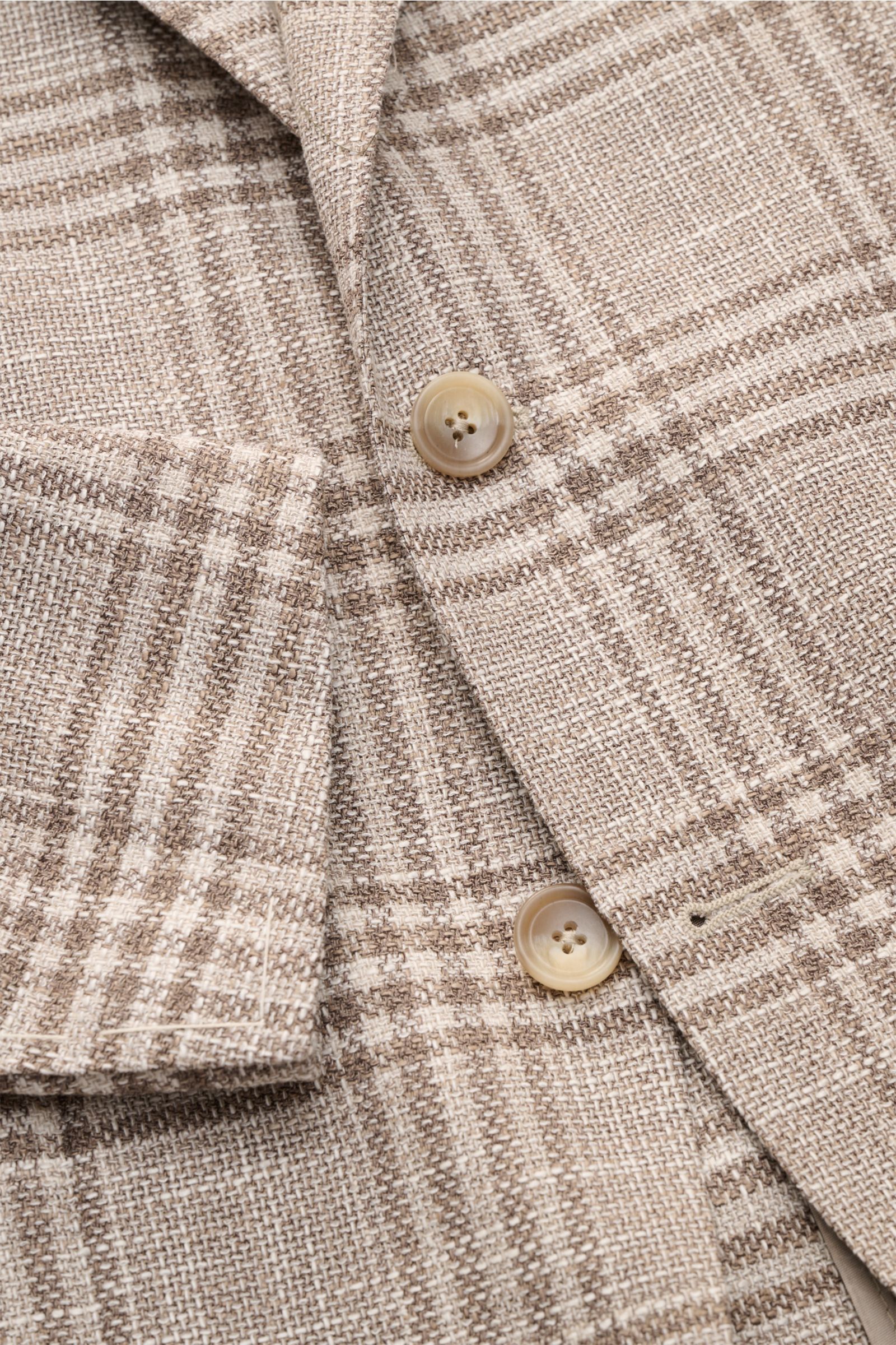 Close-up front view of Tagliatore smart-casual jacket 'Monte Carlo' beige/taupe checked showing textured blend fabric, buttons, and cuff details.

Description:  
The unconstructed finish in a fine blend of fabrics and the elegant checked pattern make t