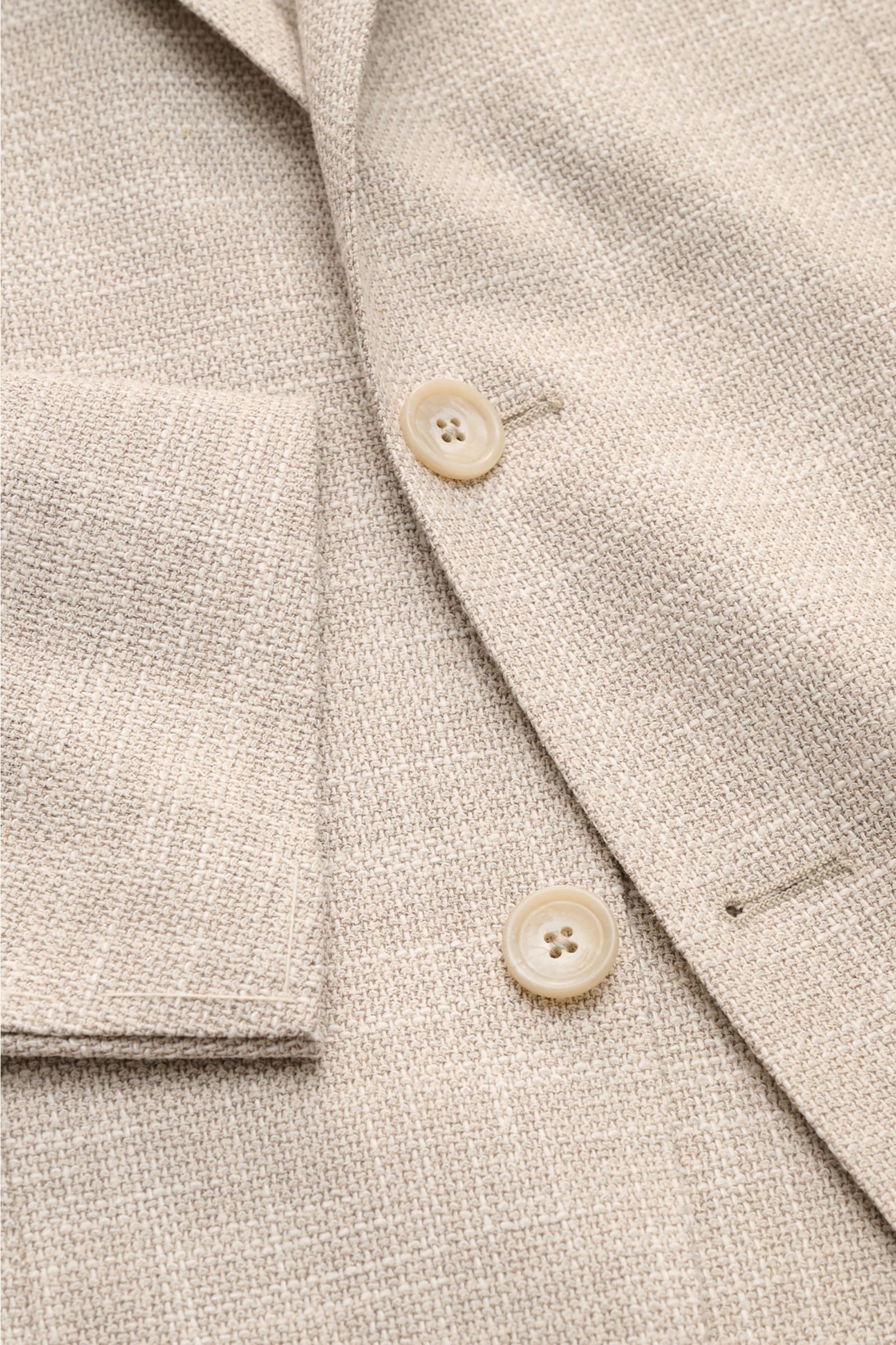 Close-up front view of the Tagliatore Smart-casual jacket 'Monte Carlo' beige mottled showing textured fabric, buttons, and patch pocket. The unconstructed finish in a fine blend of fabrics refined by effect yarn for a relaxed weave makes the smart-cas