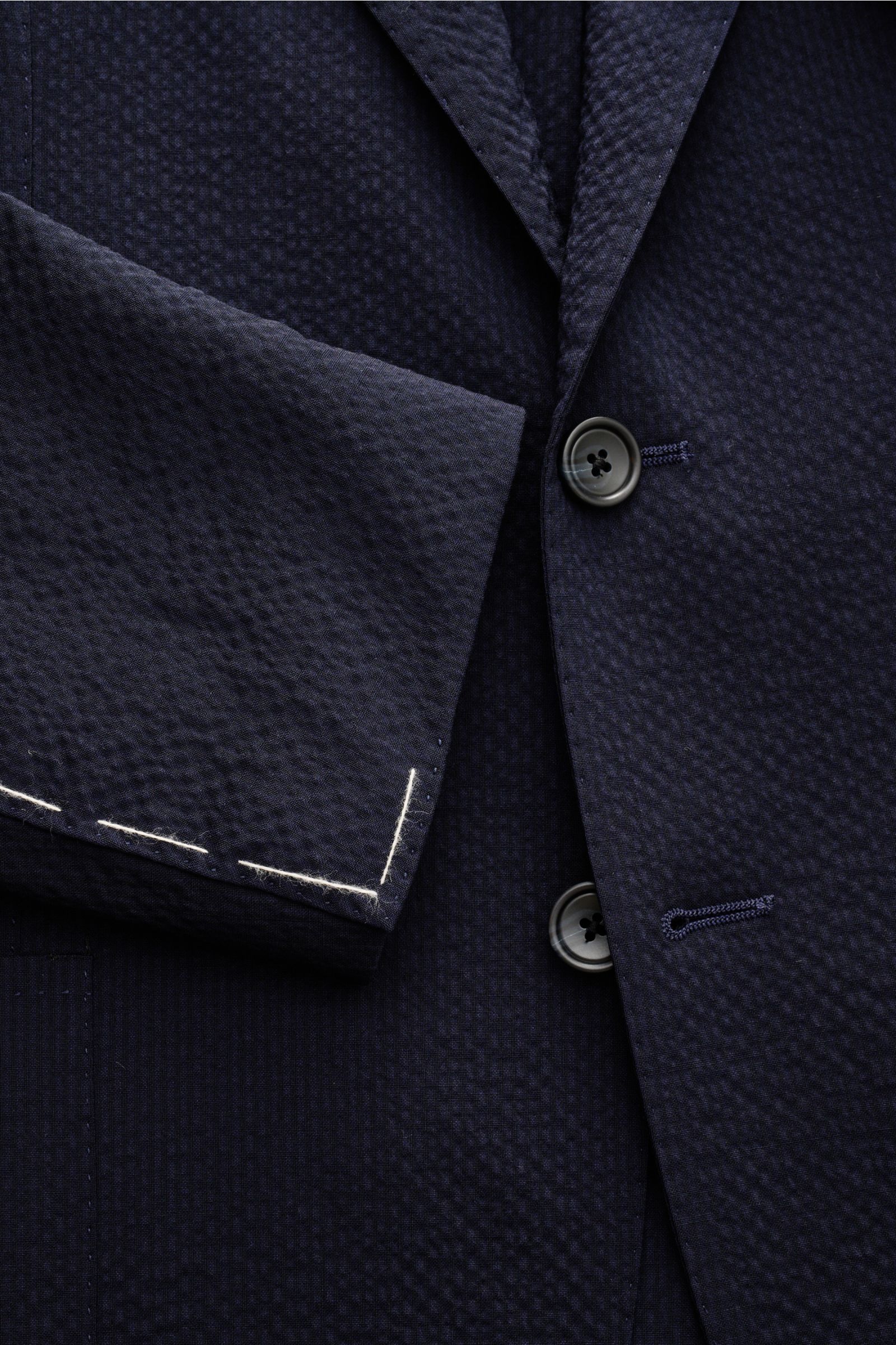 Close-up front view of Tagliatore Smart-casual jacket 'Monte Carlo' navy in lightweight elastic Super 100s seersucker wool, showing buttons and sleeve cuff stitching.