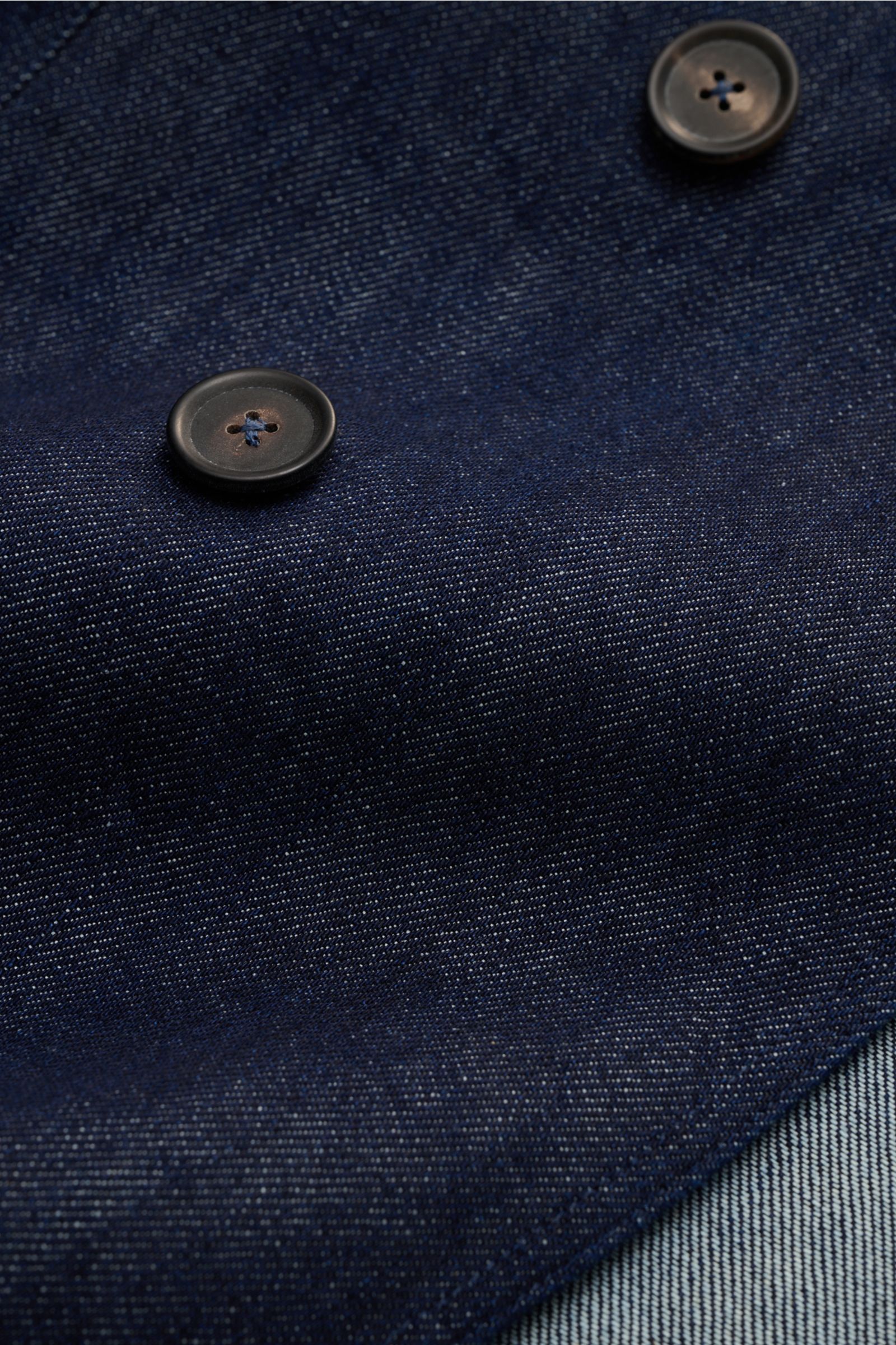 Close-up front view of Doppiaa Denim jacket 'Aansonia' navy showing double-breasted three-button style, step lapel, patch pockets, and unconstructed slim fit pure cotton denim fabric for smart-casual urban spring looks.
