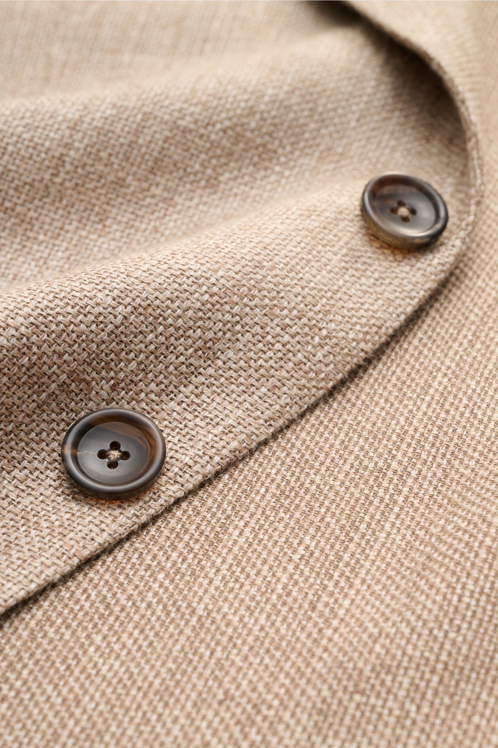 Close-up front detail of Zegna Smart-casual jacket taupe mottled showing textured linen, wool, and silk fabric with two buttons.

Hot days are guaranteed to be enjoyable in this smart-casual jacket in linen, wool and silk with distinctive mottling by Z