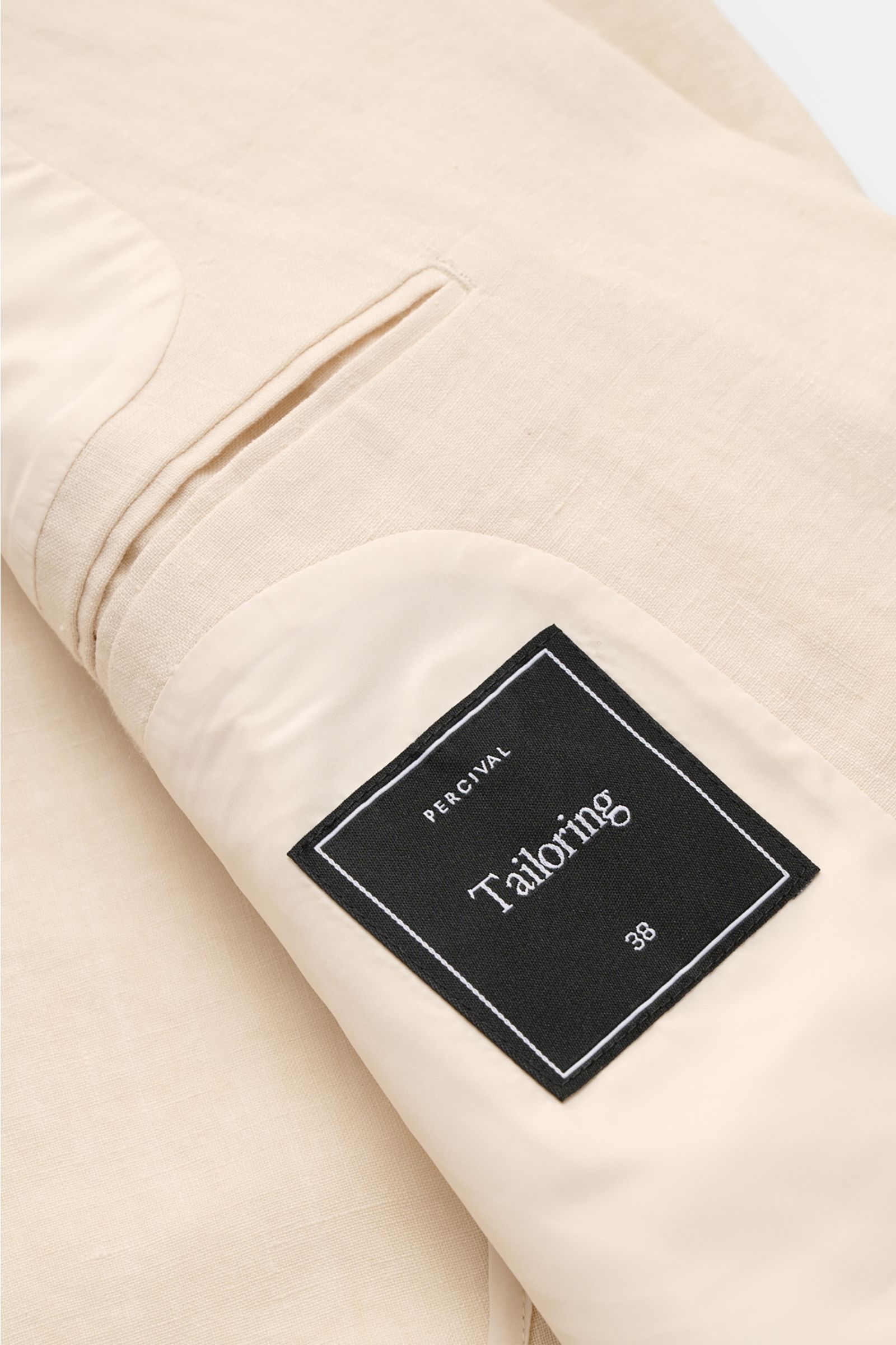 Innenansicht des cremefarbenen Percival Sakko 'Tailored Linen' aus Leinen-Baumwoll-Mix mit Innentaschen und halb gefüttertem Innenfutter.