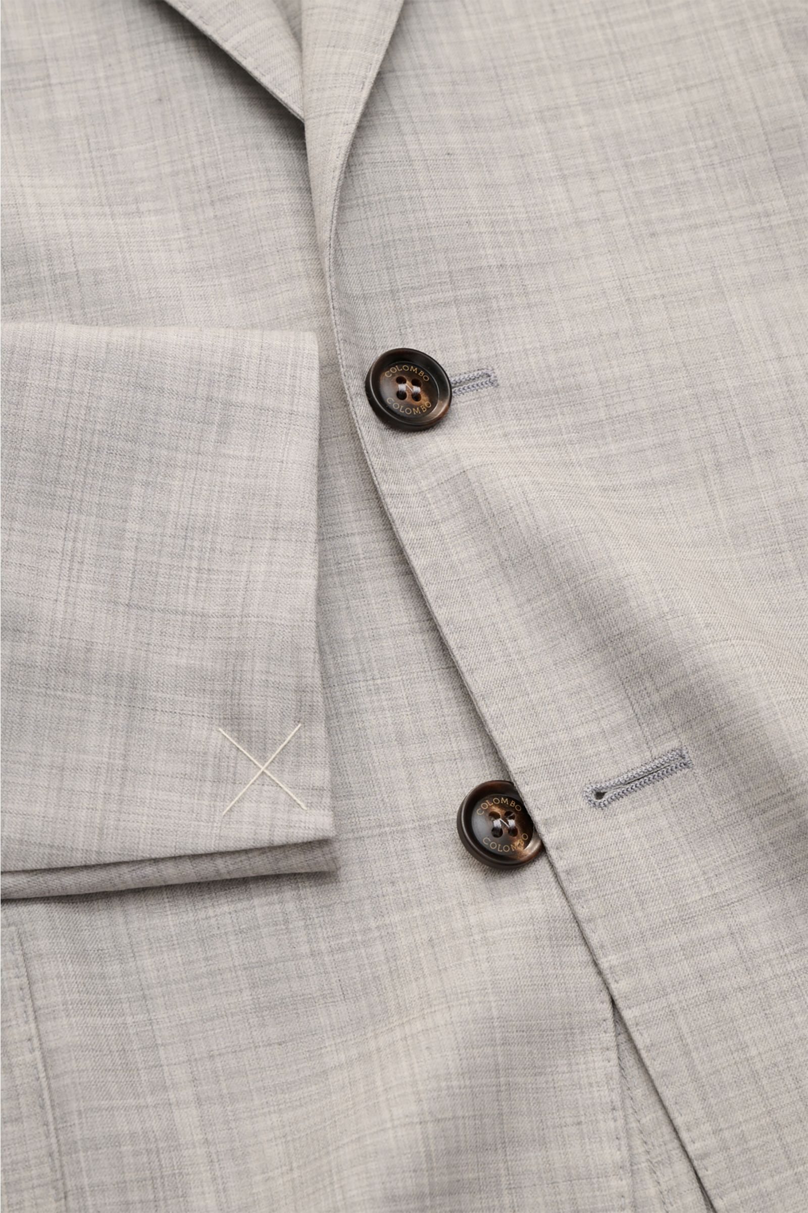 Colombo Cashmere jacket 'Robert' light grey mottled shown from a close-up front angle, featuring step lapel, two-button style, classic breast pocket, patch hip pockets, unfinished sleeve cuffs, and lightweight pure 4.0 cashmere fabric. 

Combed cashmer