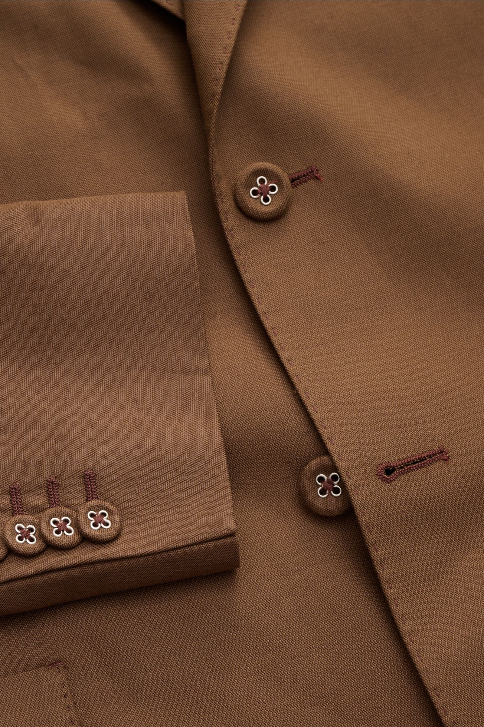 Close-up front-angle view of Officine Générale Smart-casual jacket 'Michel' brown, featuring lyocell, linen, cotton blend, buttons with floral detail, patch hip pockets, and neat stitching. Minimalist and elegant with smooth, lightweight fabric. 