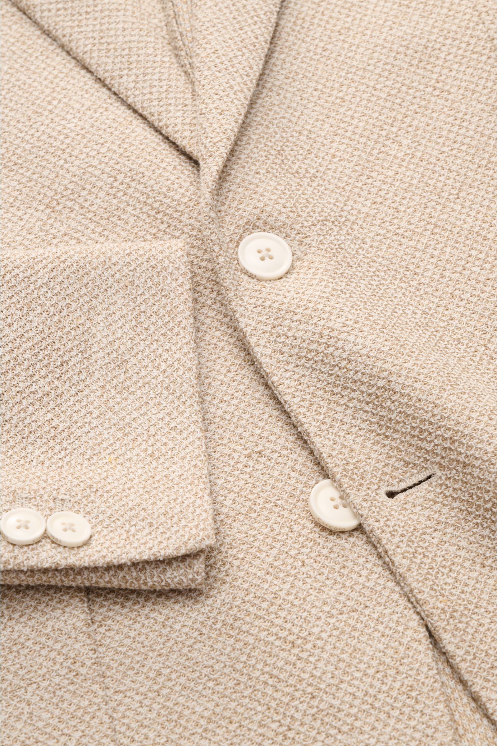 Close-up front view of the Circolo 1901 Smart-casual jacket beige mottled showing textured linen blend fabric and buttons.

This slim fit smart-casual jacket in a linen blend in slightly stretchy fabric by CIRCOLO 1901 features a contemporary unconstru