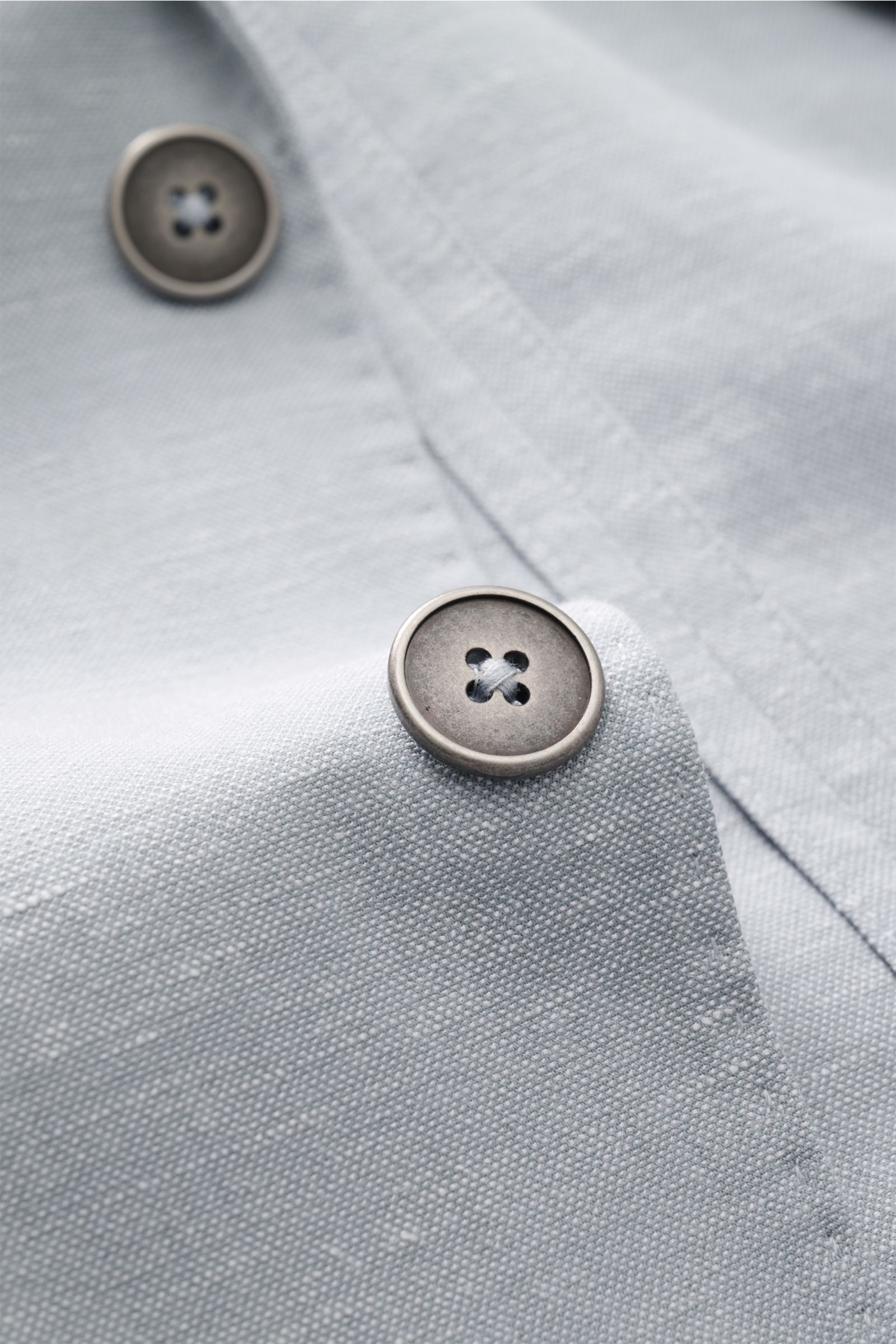 Close-up front detail of the Circolo 1901 Smart-casual jacket grey-blue mottled showing textured fabric and buttons from a top angle.

This slim fit smart-casual jacket in a cotton-linen blend in slightly stretchy fabric by CIRCOLO 1901 features a cont