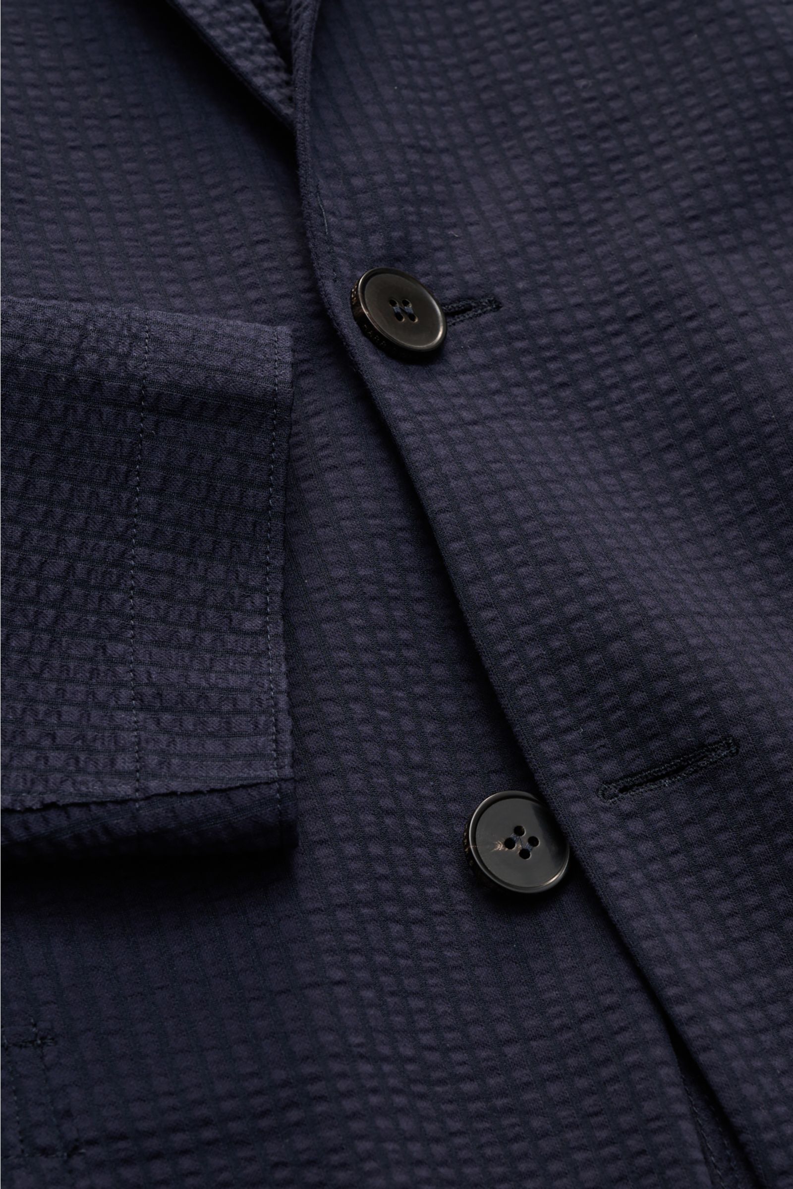 Close-up front view of Harris Wharf London Seersucker blazer navy showing textured cotton blend fabric, two-button front, patch pocket, and step lapel.

Style and unbeatable comfort: This sporty blazer in an unconstructed design by HARRIS WHARF LONDON 