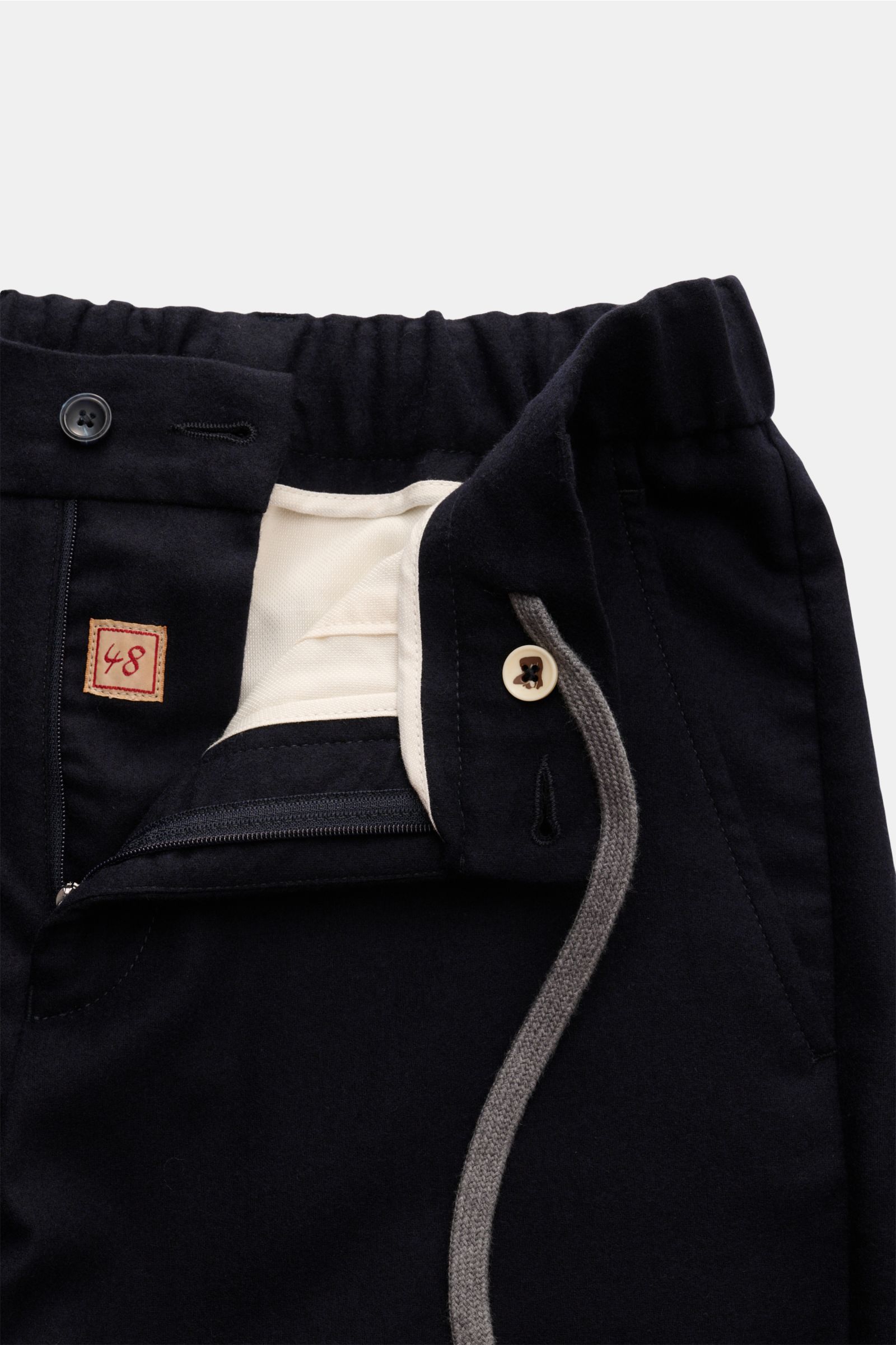 Close-up front view of Marco Pescarolo Woll-Jogpants 'Manu' navy showing elastic waistband with drawstring, zipper, button, and pocket details.