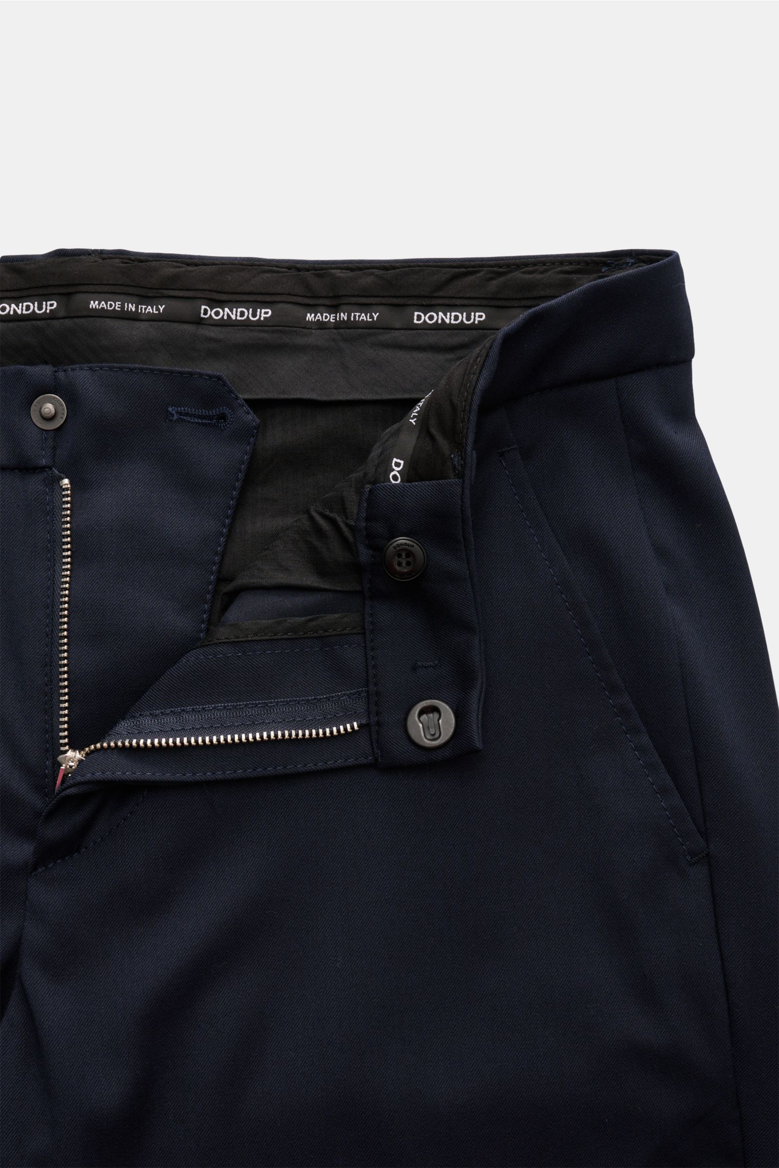 Close-up front view of Dondup Hose 'Gaubert' navy trousers showing zipper, slide button, and French pockets; mix of microfiber, wool, viscose; slim fit, soft feel, narrow calf, back button pockets, typical metal initial.