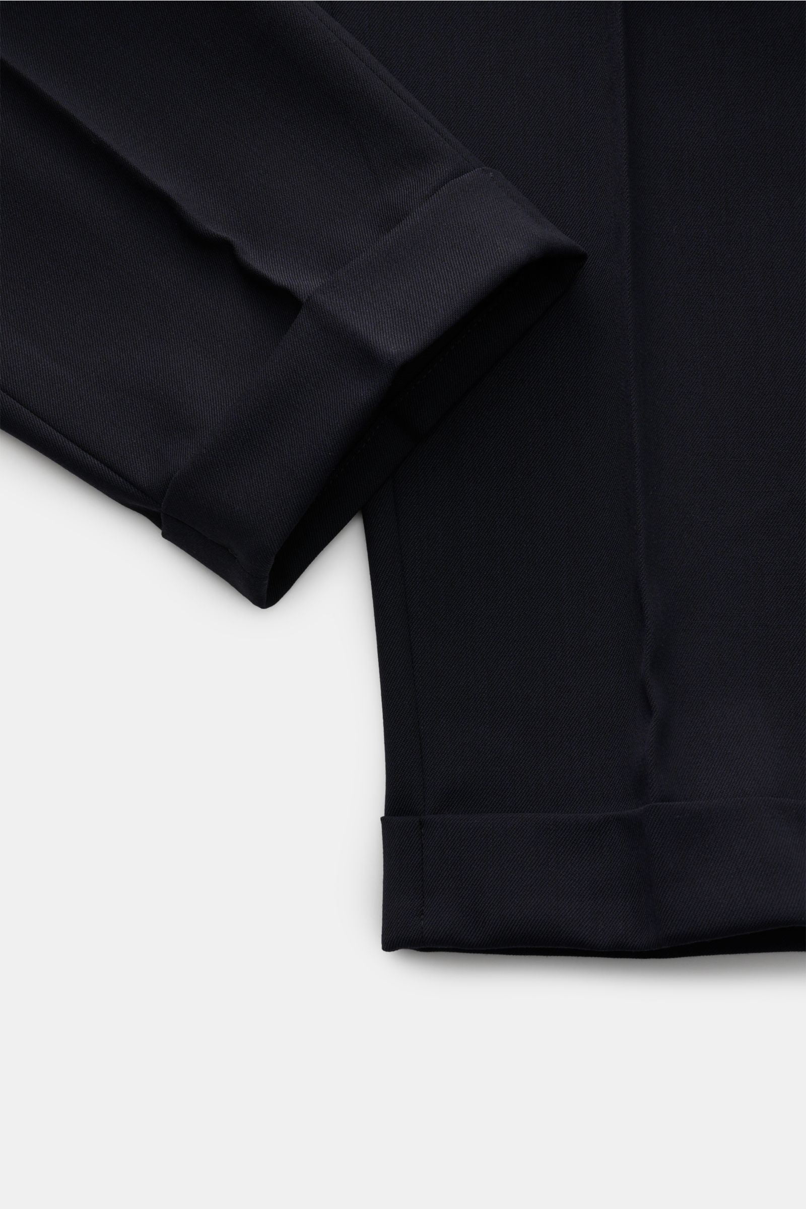 Close-up image of the cuff and lower leg area of the PT Torino Hose 'Rebel Fit' navy, photographed from a top-down angle, showing twill microfiber and wool fabric with a slightly elastic, lightly textured feel, Rebel Fit taper, regular thigh width, ankle 