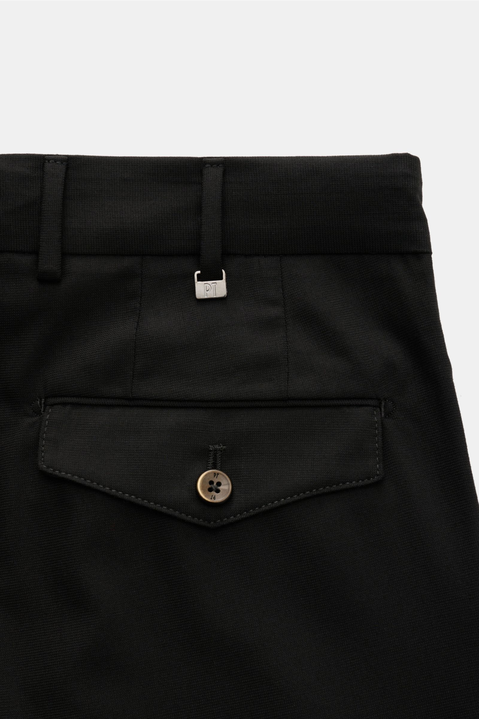 Close-up rear view of PT Torino Jersey trousers 'Carrot Fit' black, showing back pocket with flap, button, and belt loops in a smooth wool blend fabric. With their short cut, stylish pleats and elongated buttoned tab, the jersey trousers 'Carrot Fit' by P
