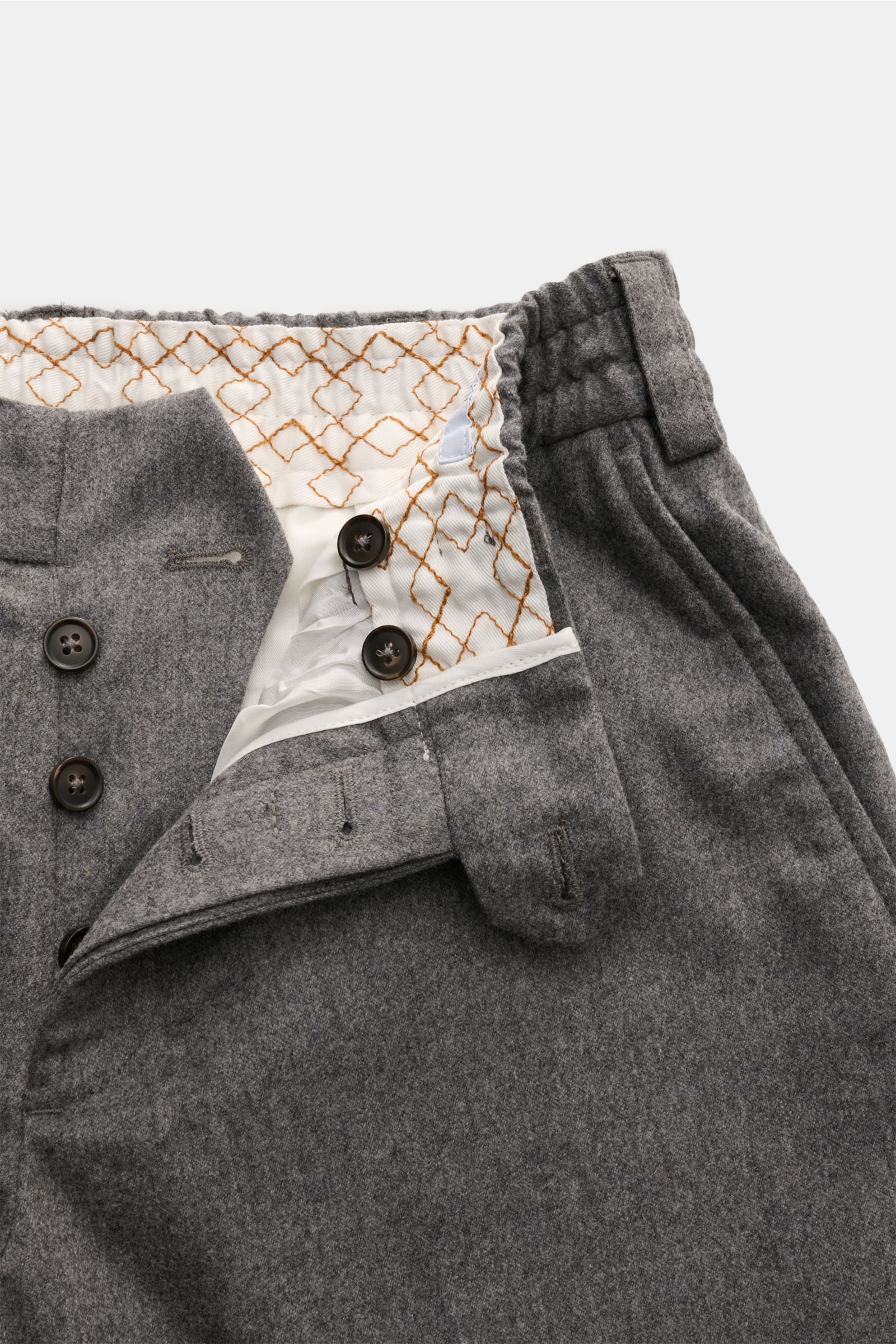 Detailansicht der geöffneten PT Torino Woll-Jogpants 'The Rebel' grau meliert mit Button-Fly, elastischem Bund, weichem Griff, elastischer Qualität und Innenfutter, fotografiert von oben.