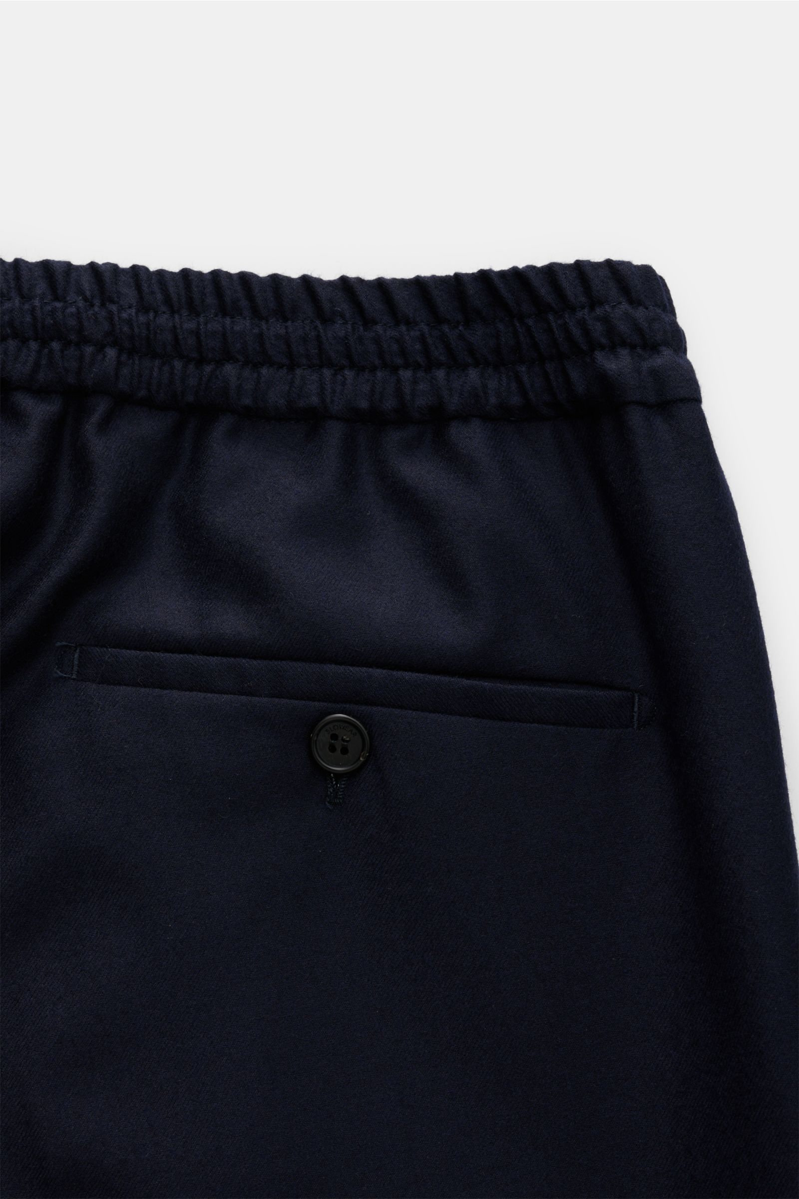 Close-up rear view of Incotex Wool jogger pants navy showing elasticated waistband and jetted back pocket with button.

Description: For perfect looks: These jogger pants in high-quality, pure wool in a regular fit by INCOTEX are a casual alternative f