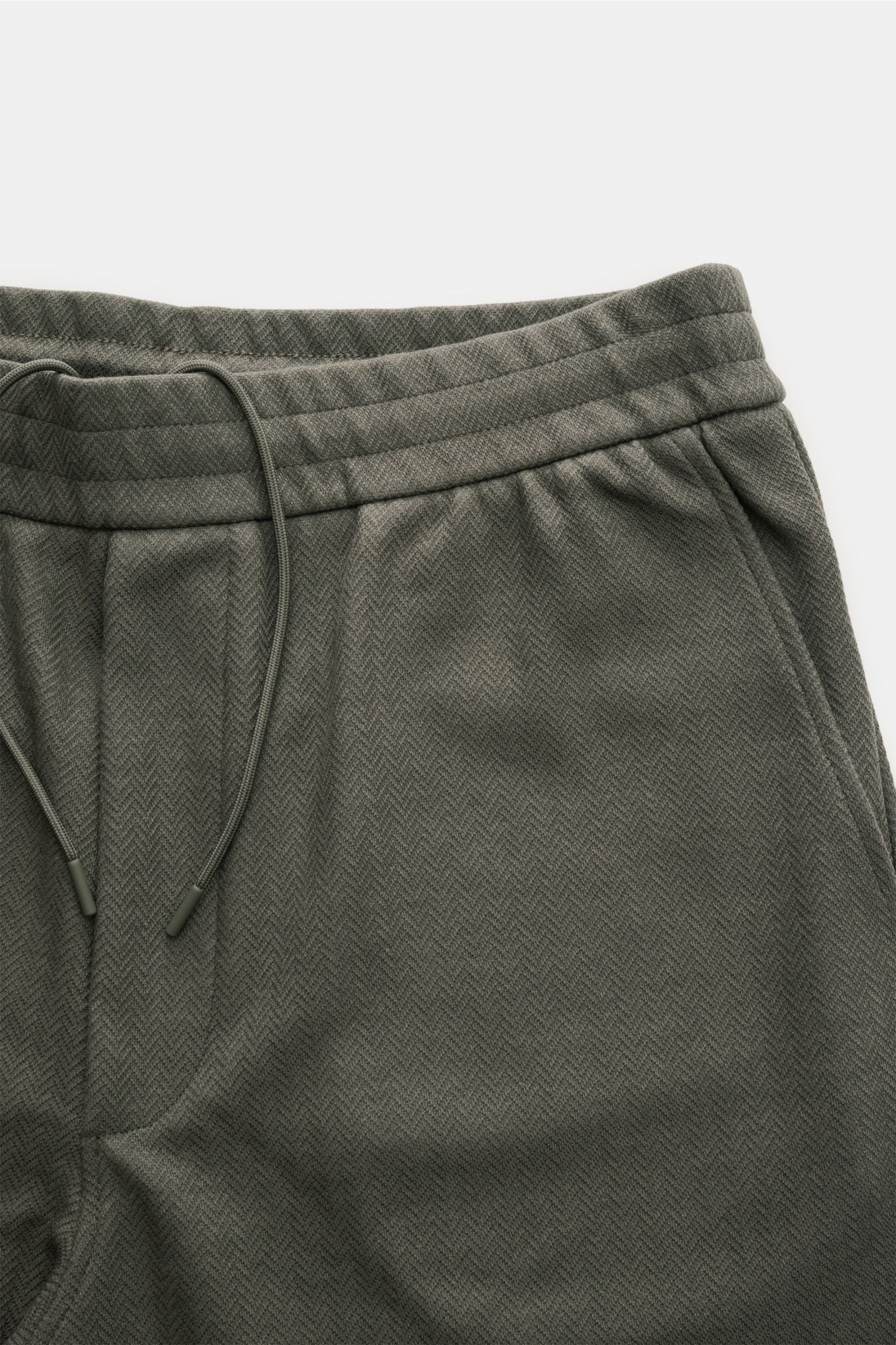 Close-up front view of Emporio Armani Jogger pants dark grey featuring an elasticated waistband with drawstring, French pockets, and a slightly textured cotton-Lyocell blend fabric.