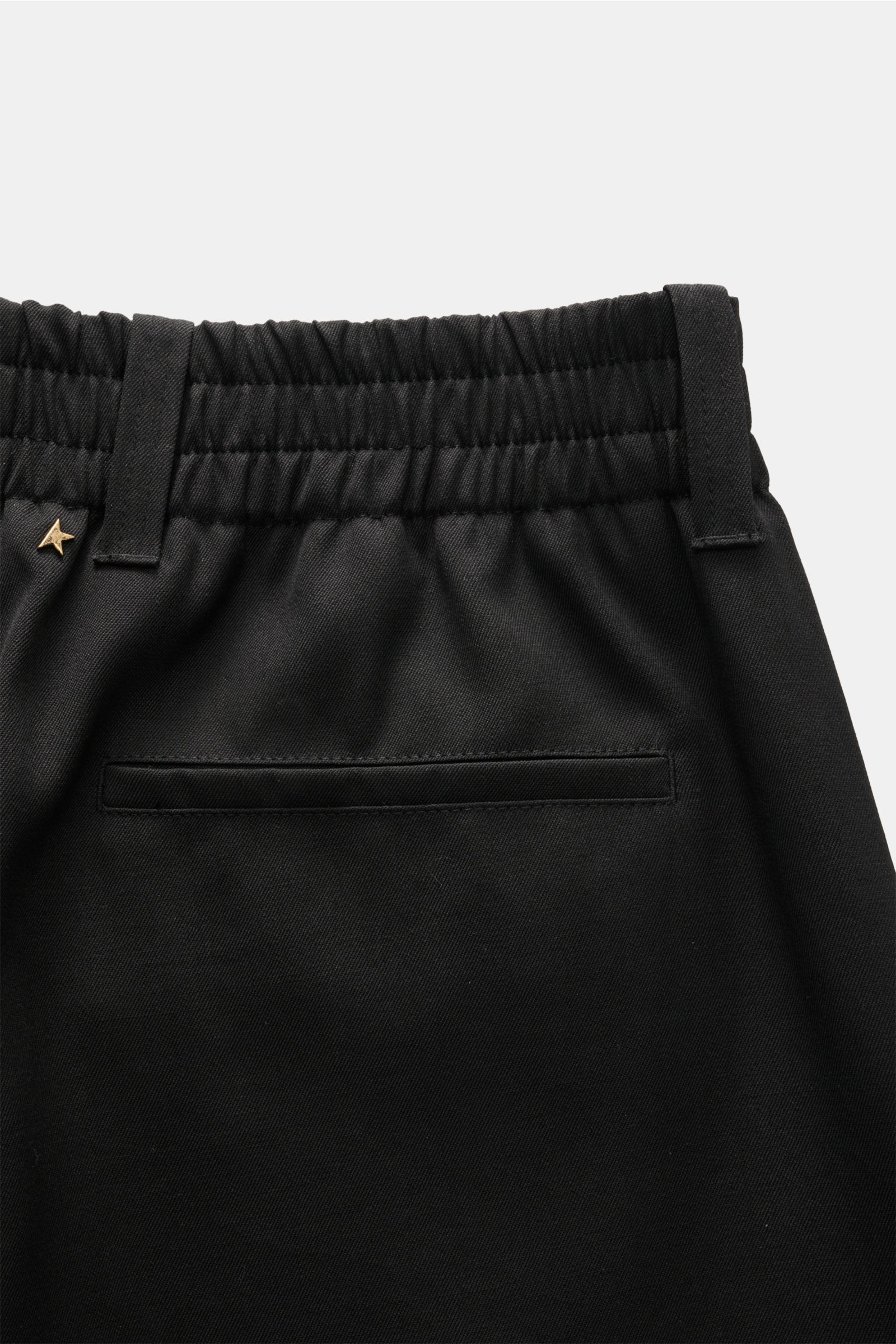 Close-up rear view of Golden Goose Wool trousers black, showing elasticated waistband, rivet detail, and back hip pocket in black virgin wool twill.