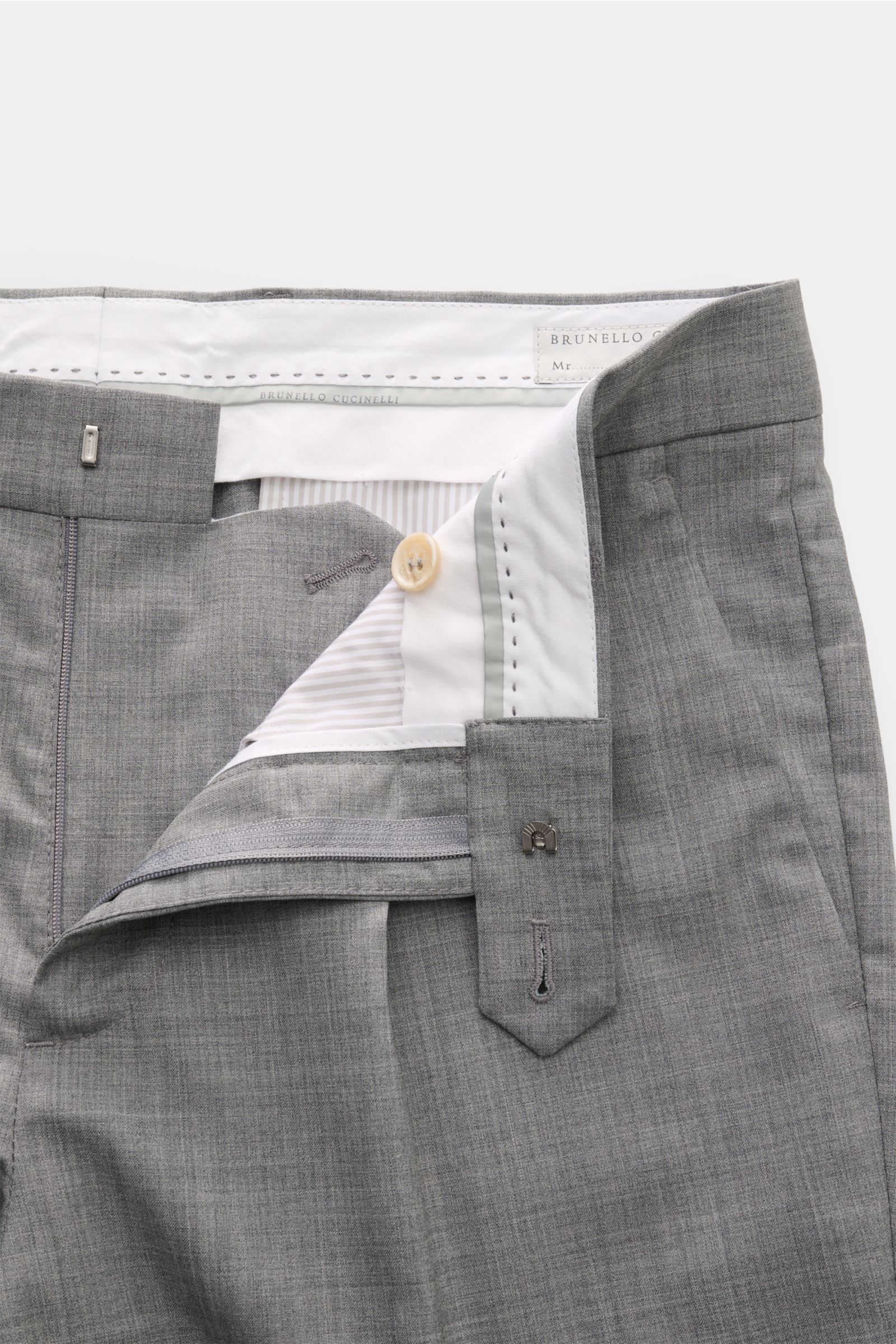 Close-up front view of Brunello Cucinelli Wollhose grau meliert showcasing the open waistband, zipper, and button details in fine gray wool fabric.

Ikonisches Essential in italienischer Luxusausführung: Die edle Wollhose mit klassischer Bundfalte von 
