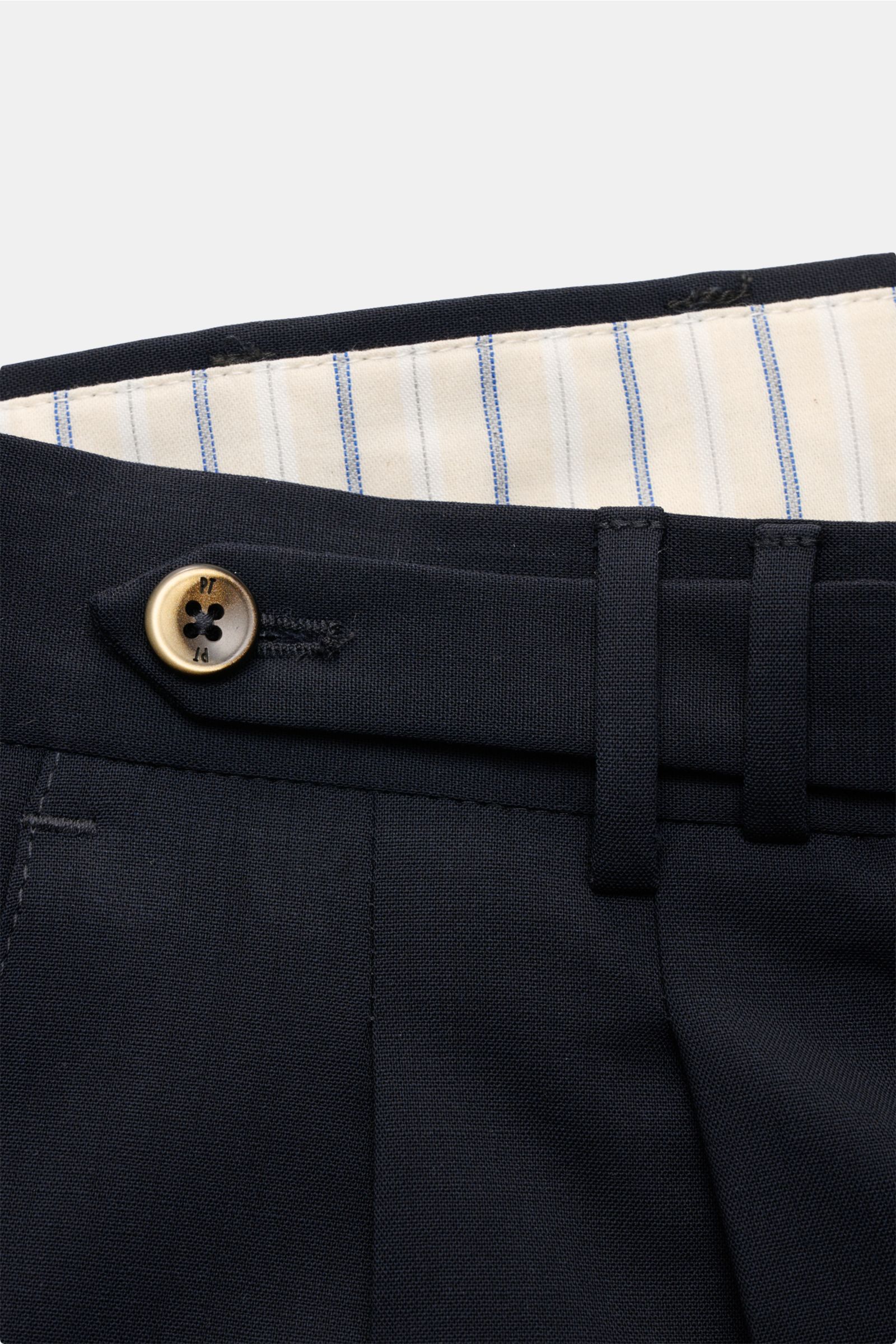 Close-up front view of PT Torino Wool trousers 'Carrot Fit' navy, showing elasticated virgin wool fabric, double pleat, extended buttoned tab, and striped inner waistband. Classic elegance with a modern twist: With their short cut, stylish pleats and exte