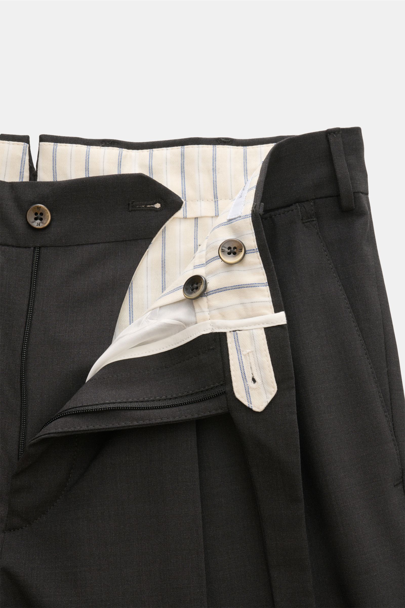 Close-up front view of PT Torino Wool trousers 'Carrot Fit' anthracite mottled showing open waistband with striped inner lining, zip, buttons, and extended buttoned tab. Classic elegance with a modern twist: With their short cut, stylish pleats and extend