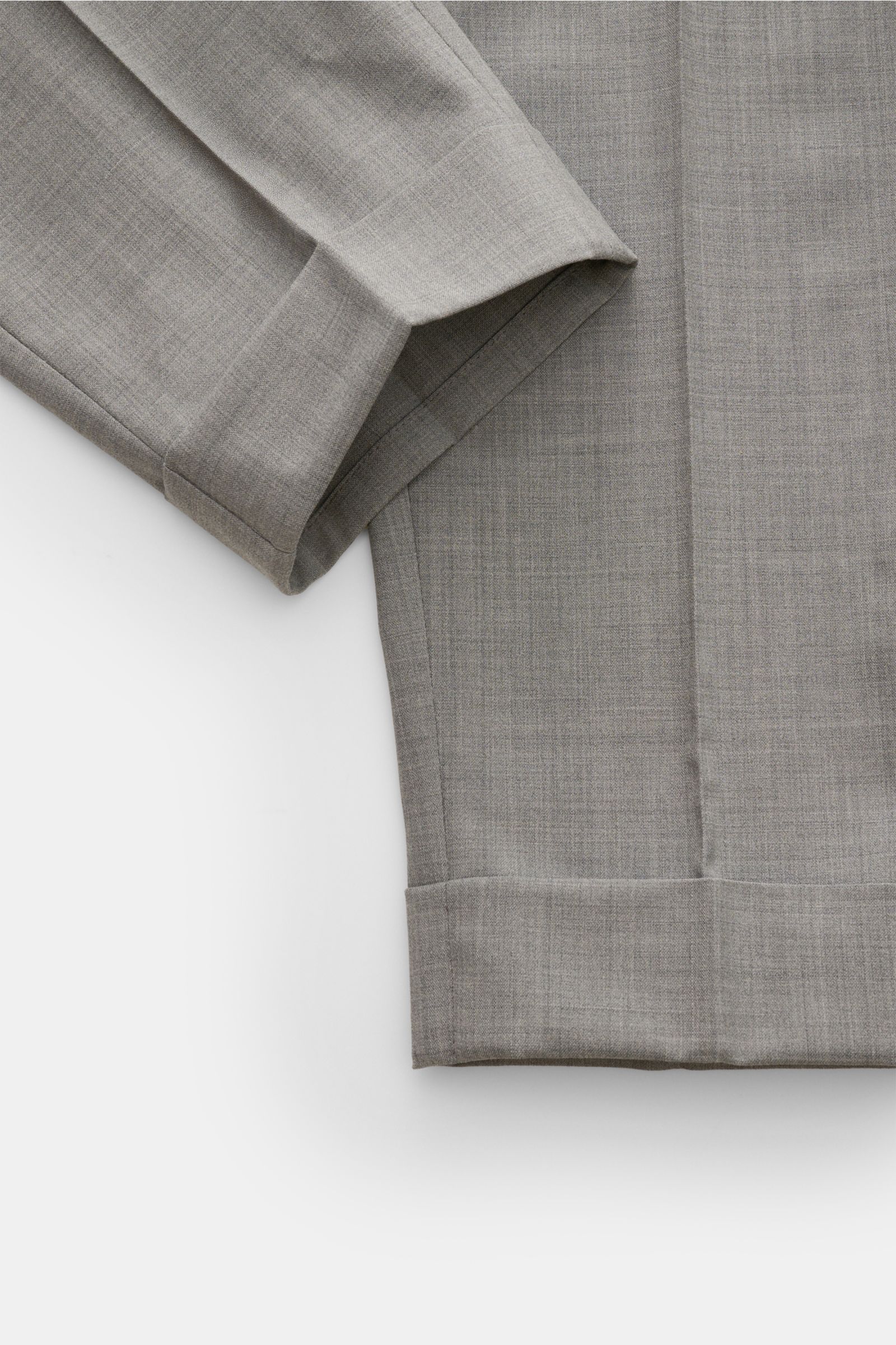 Close-up top-down view of PT Torino Wool trousers 'Carrot Fit' grey mottled, showing ankle length, fixed hem turn-up, and soft virgin wool fabric with double pleat. Classic elegance with a modern twist: With their short cut, stylish pleats and extended bu